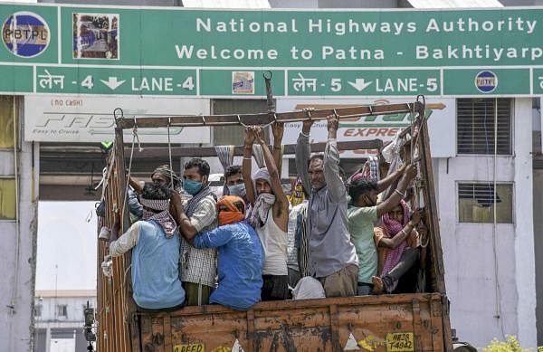 Migrants travel in a truck to their native places, during the ongoing nationwide lockdown to curb the spread of coronavirus, in Patna, Sunday, May 17, 2020. (PTI Photo)