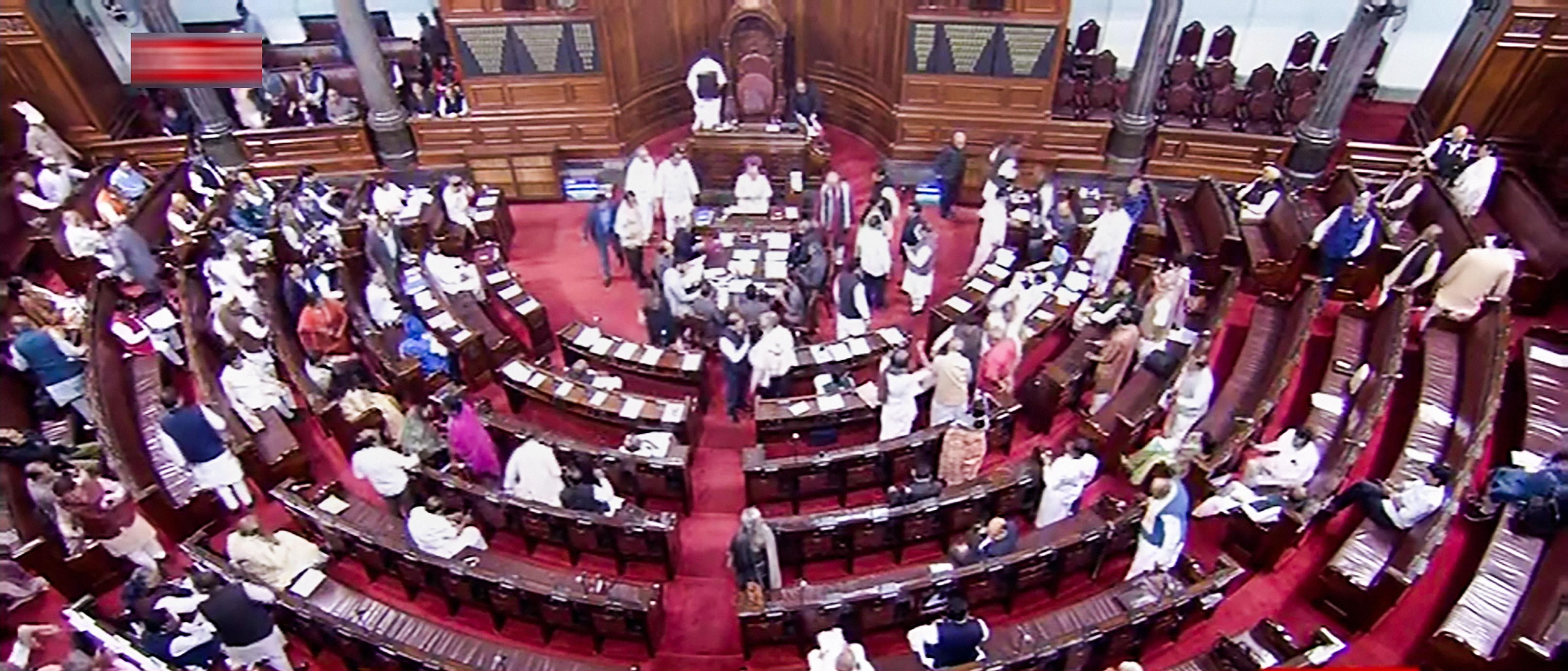 Opposition members protest in the Rajya Sabha during the Budget Session of Parliament, in New Delhi. (Credit: PTI Photo)