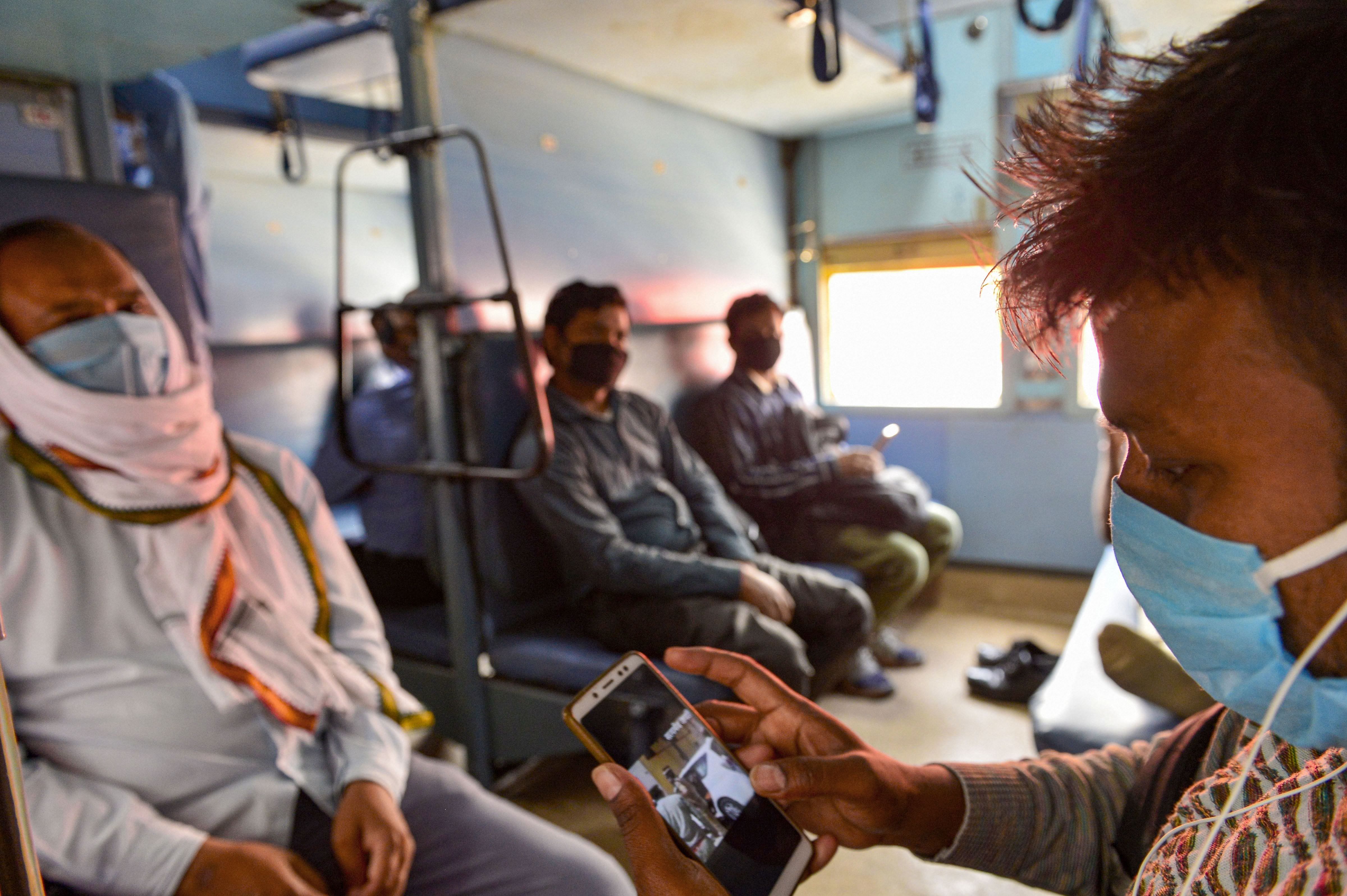 Railways employees travel in a local train after their duty during the nationwide lockdown, in wake of the coronavirus pandemic, in New Delhi. (PTI Photo)