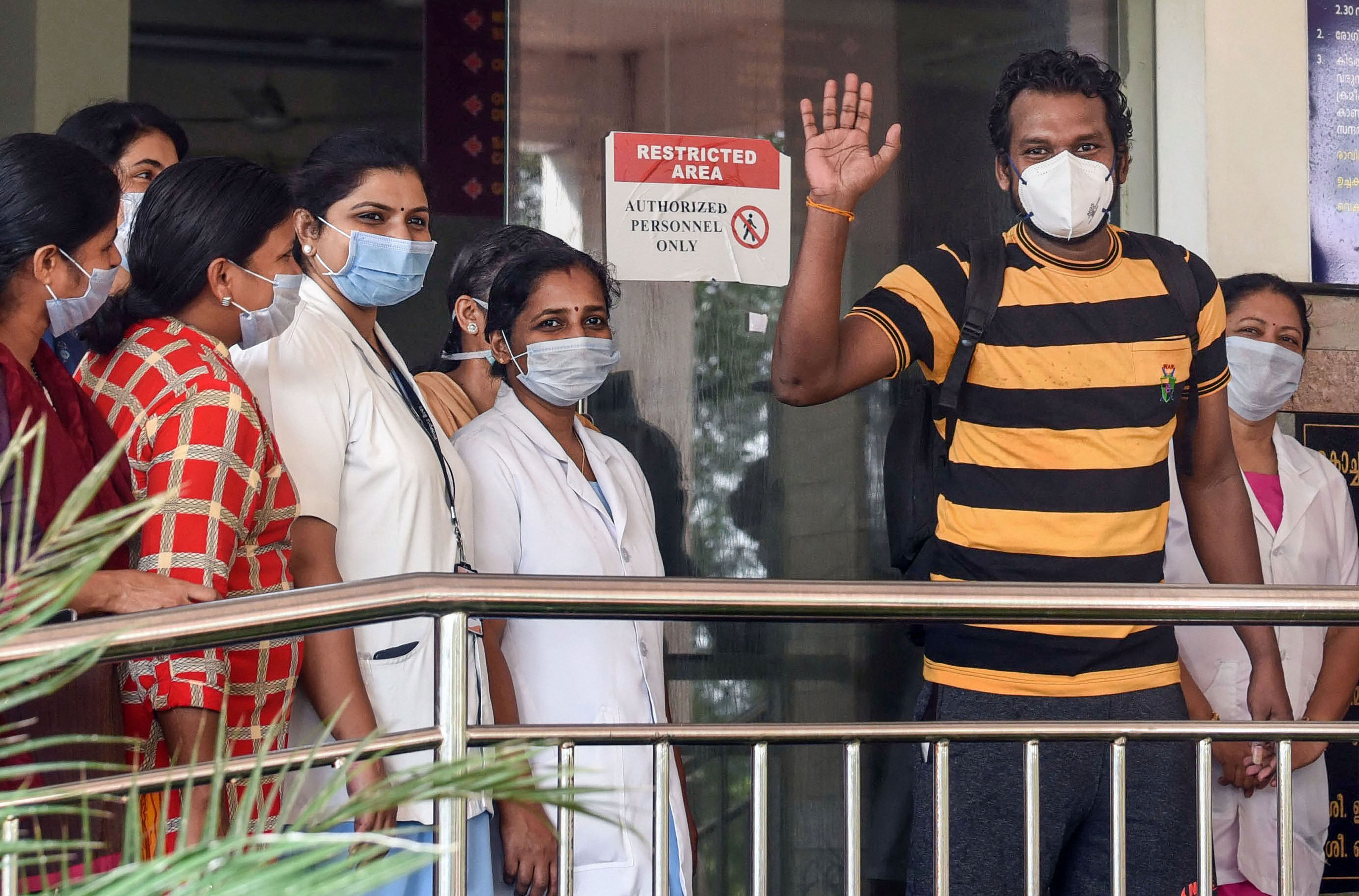Taxi driver Latheesh waves as he leaves after being discharged from a hospital following his recovery from COVID-19. (PTI Photo)