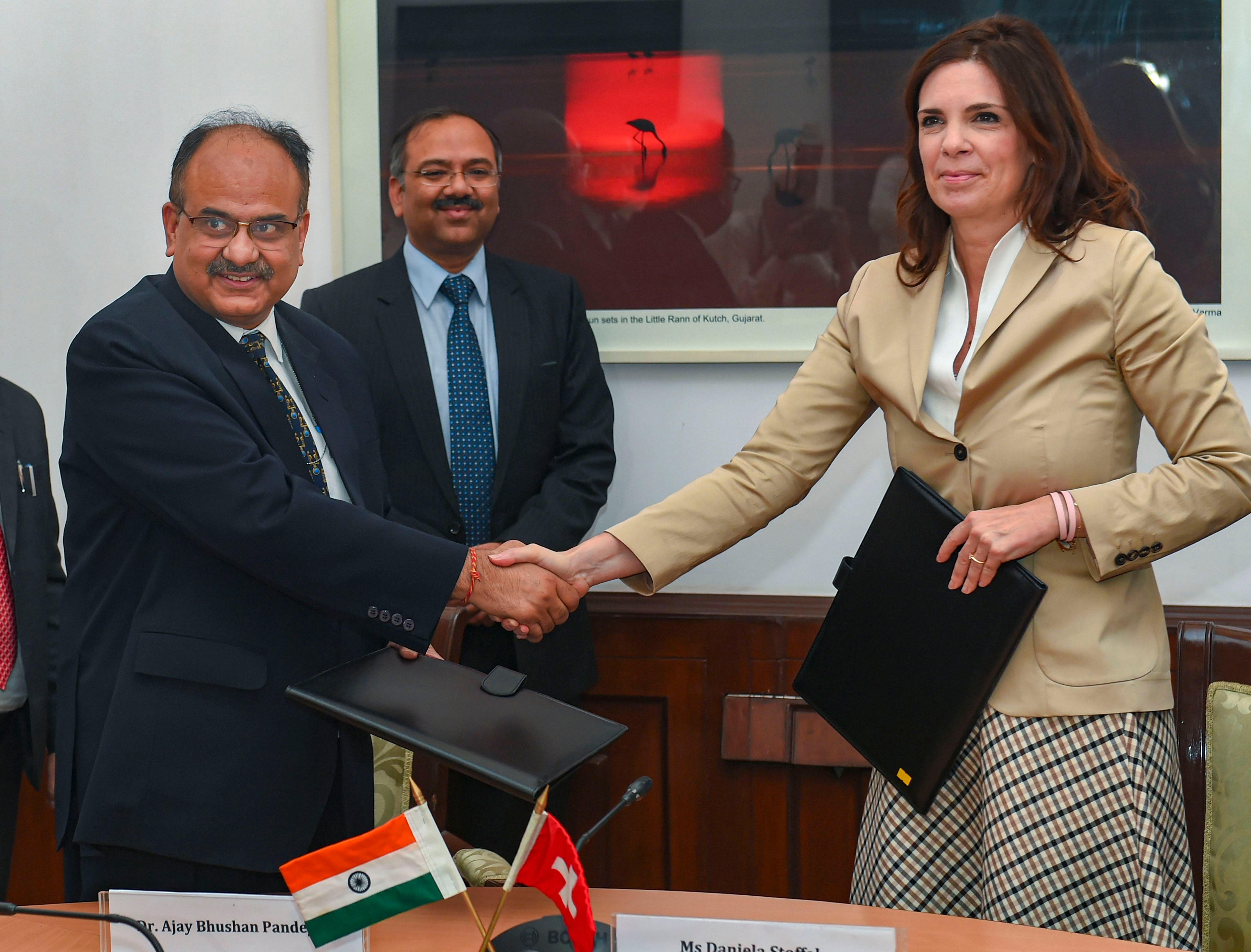 Revenue Secretary Ajay Bhushan Pandey shakes hands with Daniela Stoffel, Switzerland's State Secretary for International Finance, after signing the Secretary-level bilateral agreement between India and Switzerland. (PTI Photo)