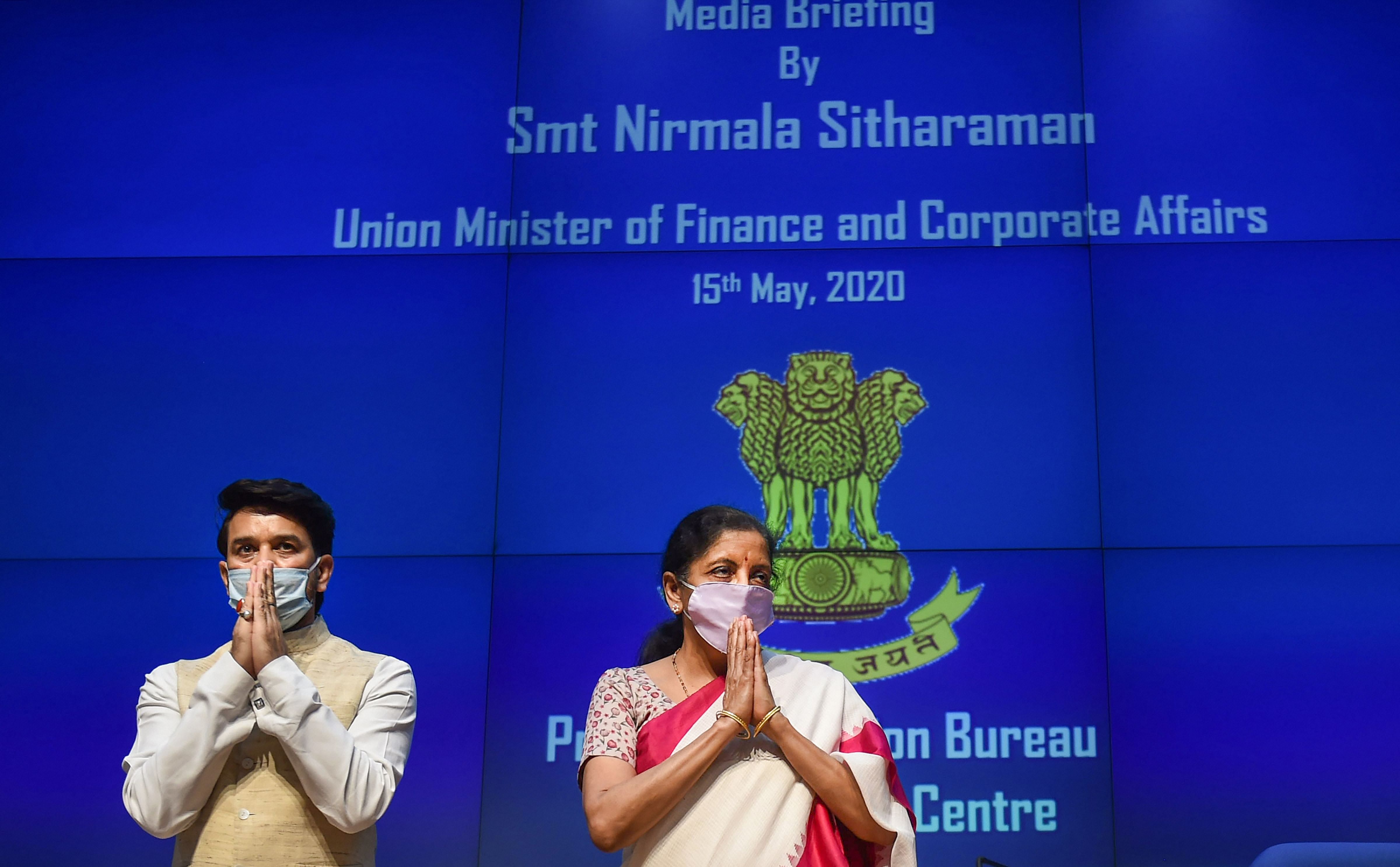 Union Finance Minister Nirmala Sitharaman along with MoS for Finance Anurag Thakur greets media personnel during a press conference, in New Delhi. (PTI)