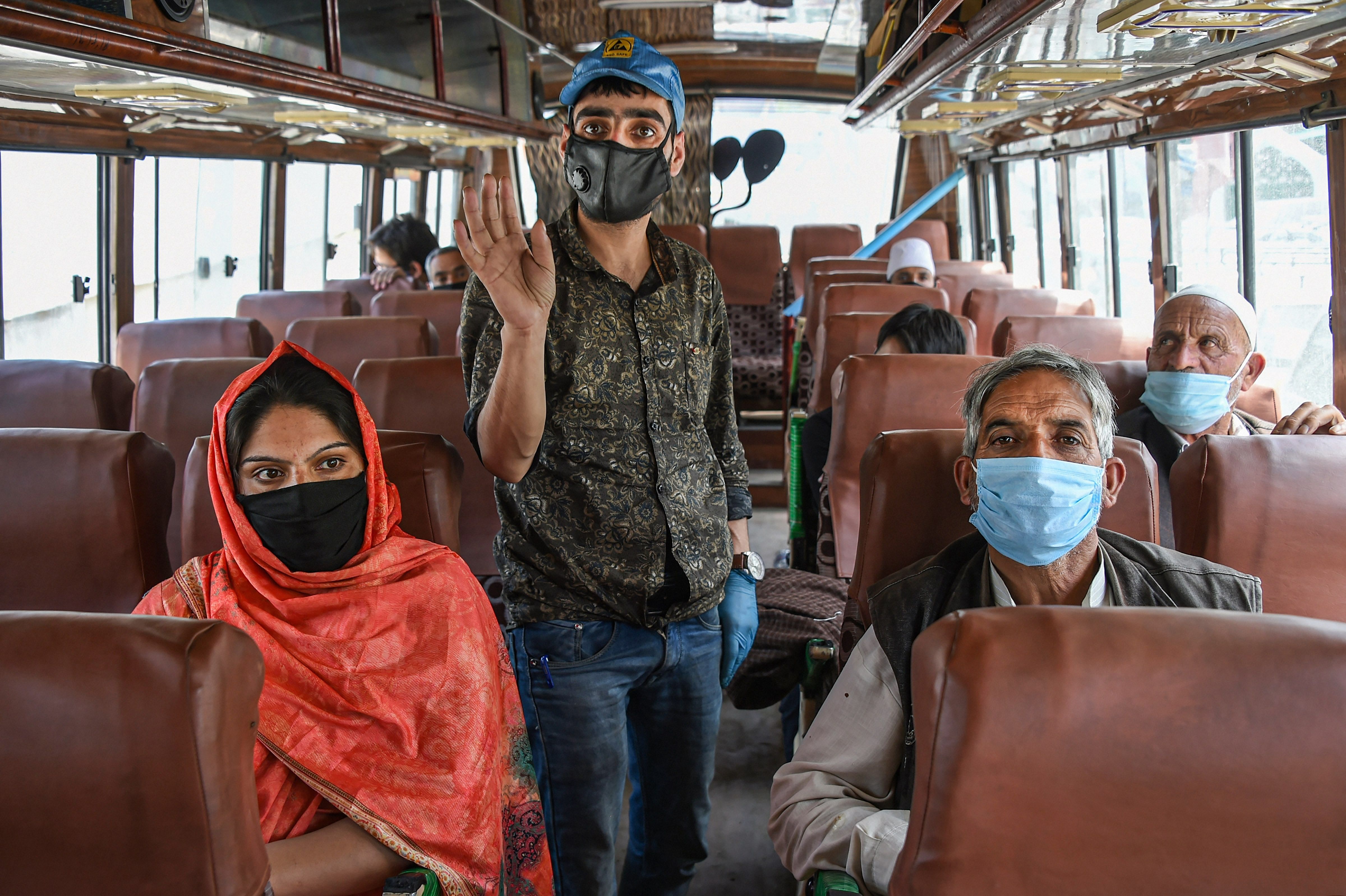 Kashmiri businessman and students, who were stranded in different parts of the country, arrive in a bus at Tourist Reception Center during the nationwide COVID-19 lockdown, in Srinagar. (PTI)