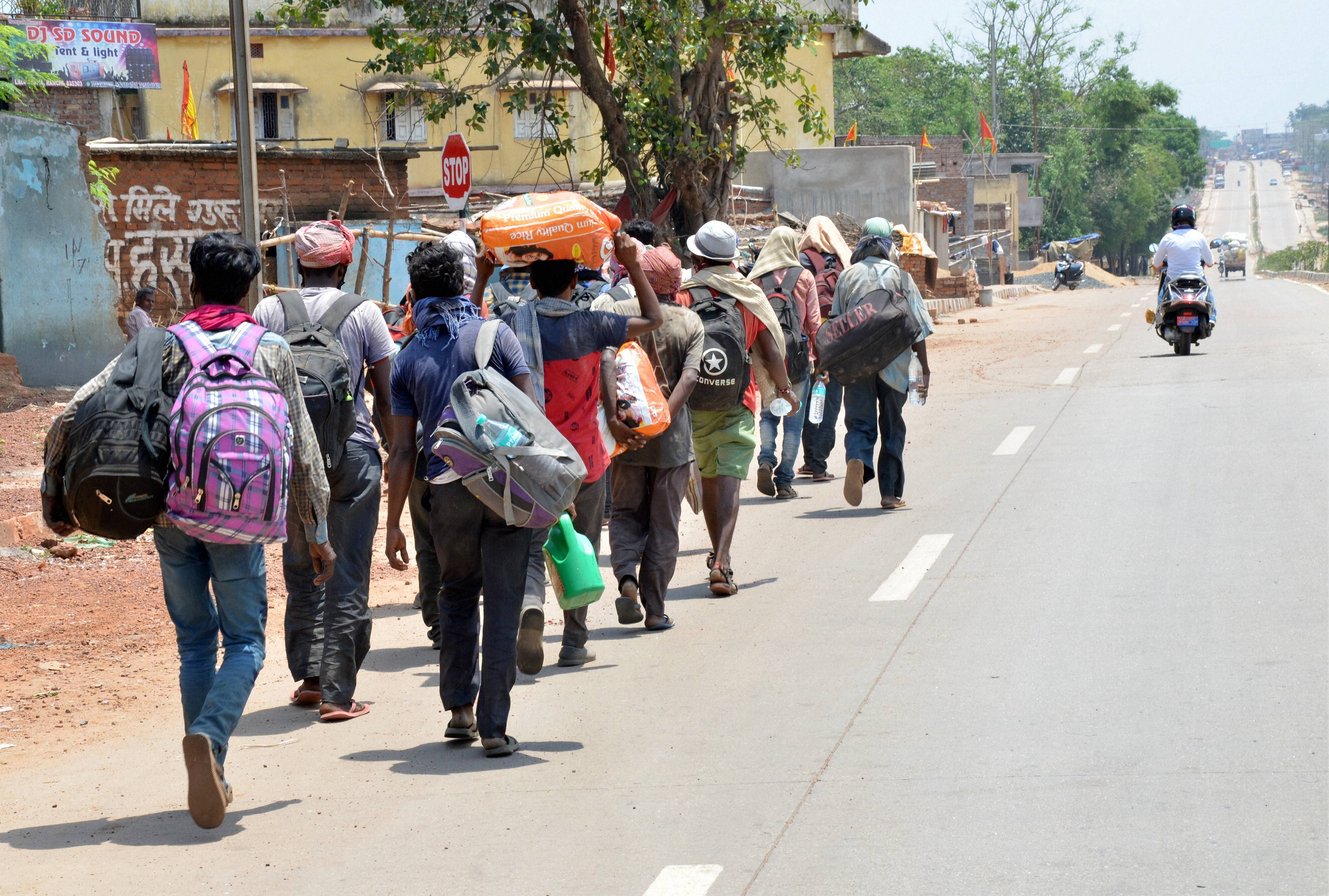 Migrants coming from Andhra Pradesh on their way to their native place Jhalda (West Bengal) at Ranchi-Gumla-Chattisgarh National Highway. (PTI Photo)