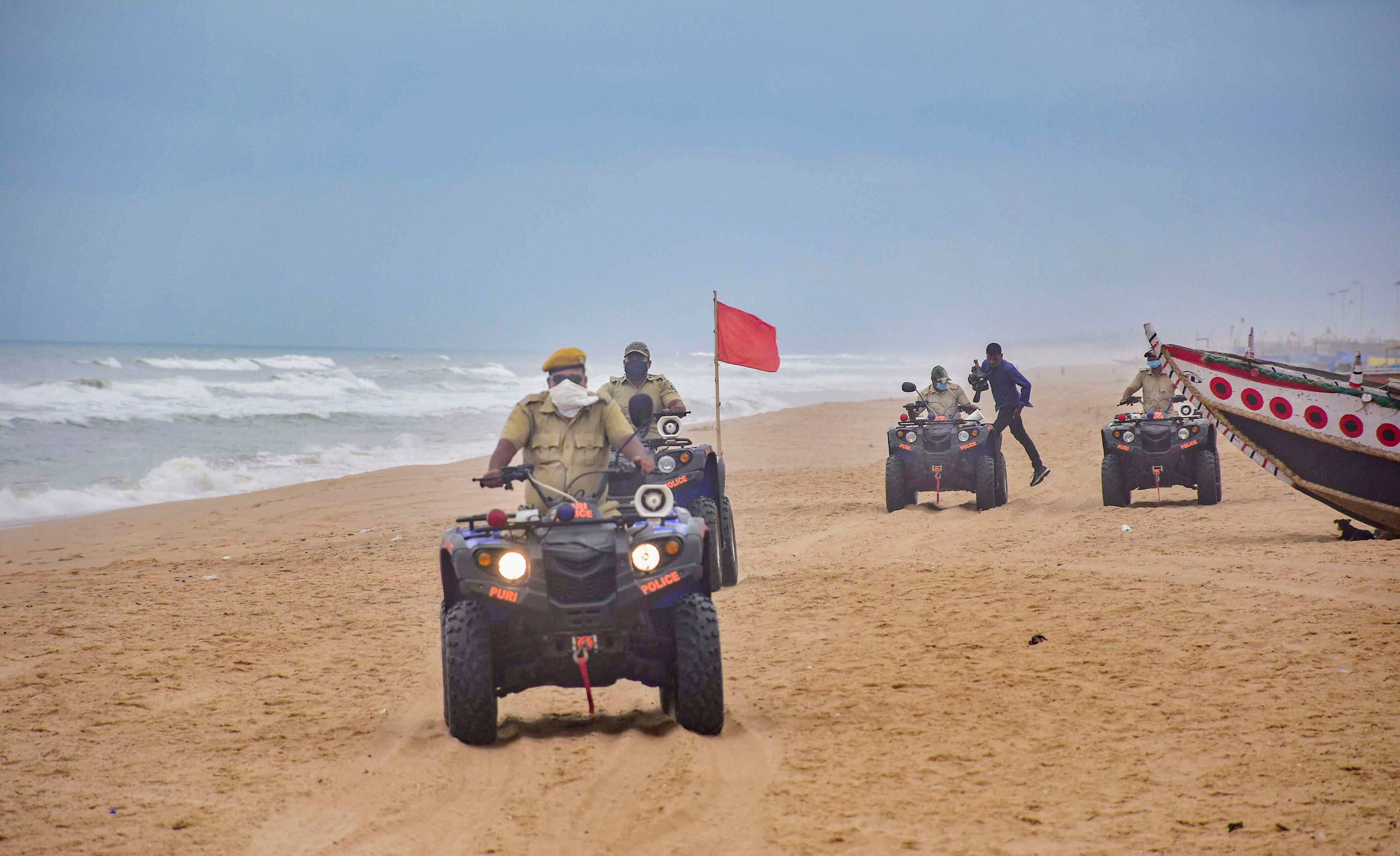 Marine police personnel patrol Puri beach to prevent tourists and fishermen from venturing into the sea due to Cyclone Amphan, in Puri. (PTI)