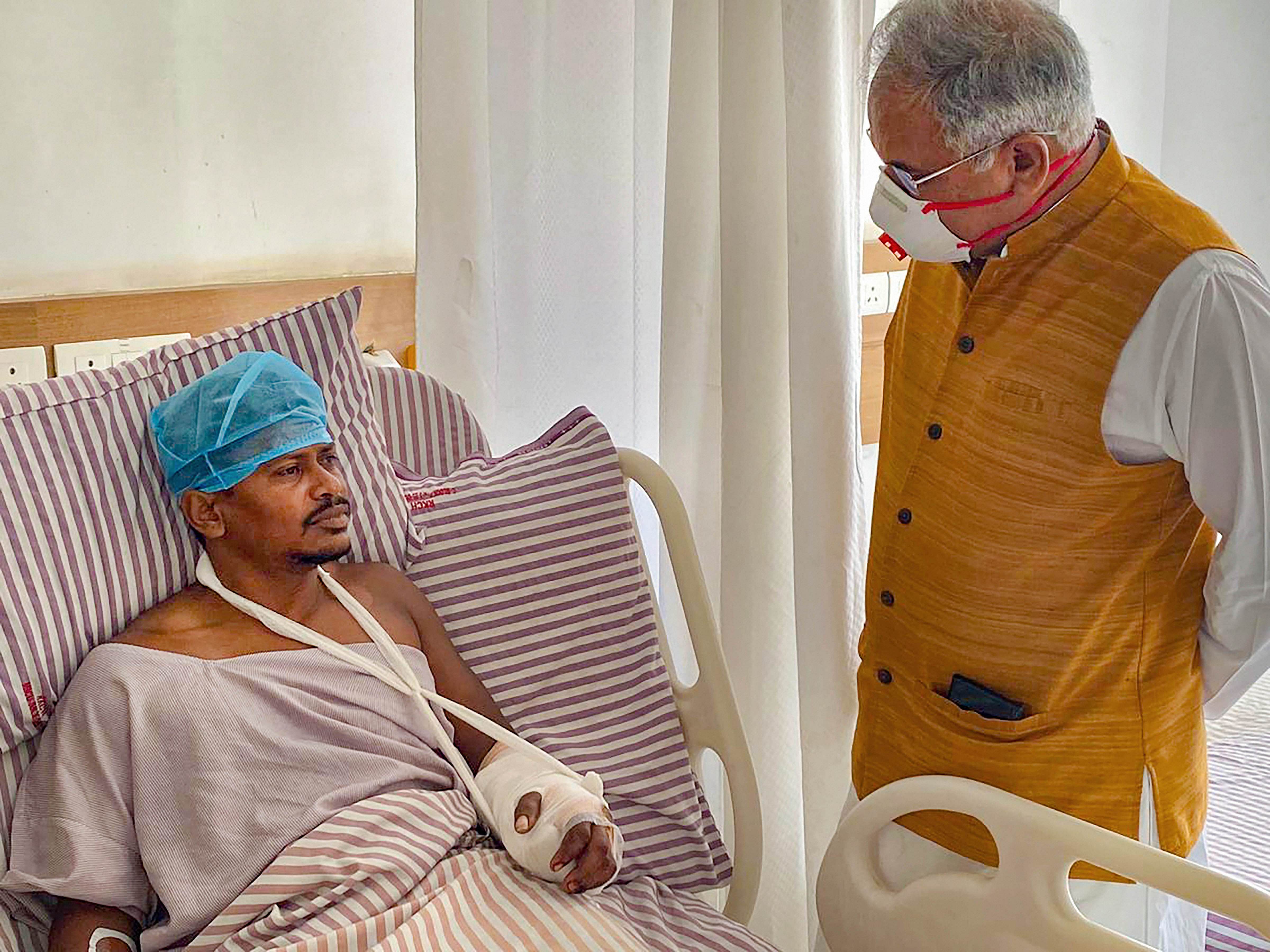 Chhattisgarh Chief Minister Bhupesh Baghel meets injured police personnel, at Ramkrishna Care Hospital in Raipur, Sunday, March 22, 2020. (Credit: PTI Photo)