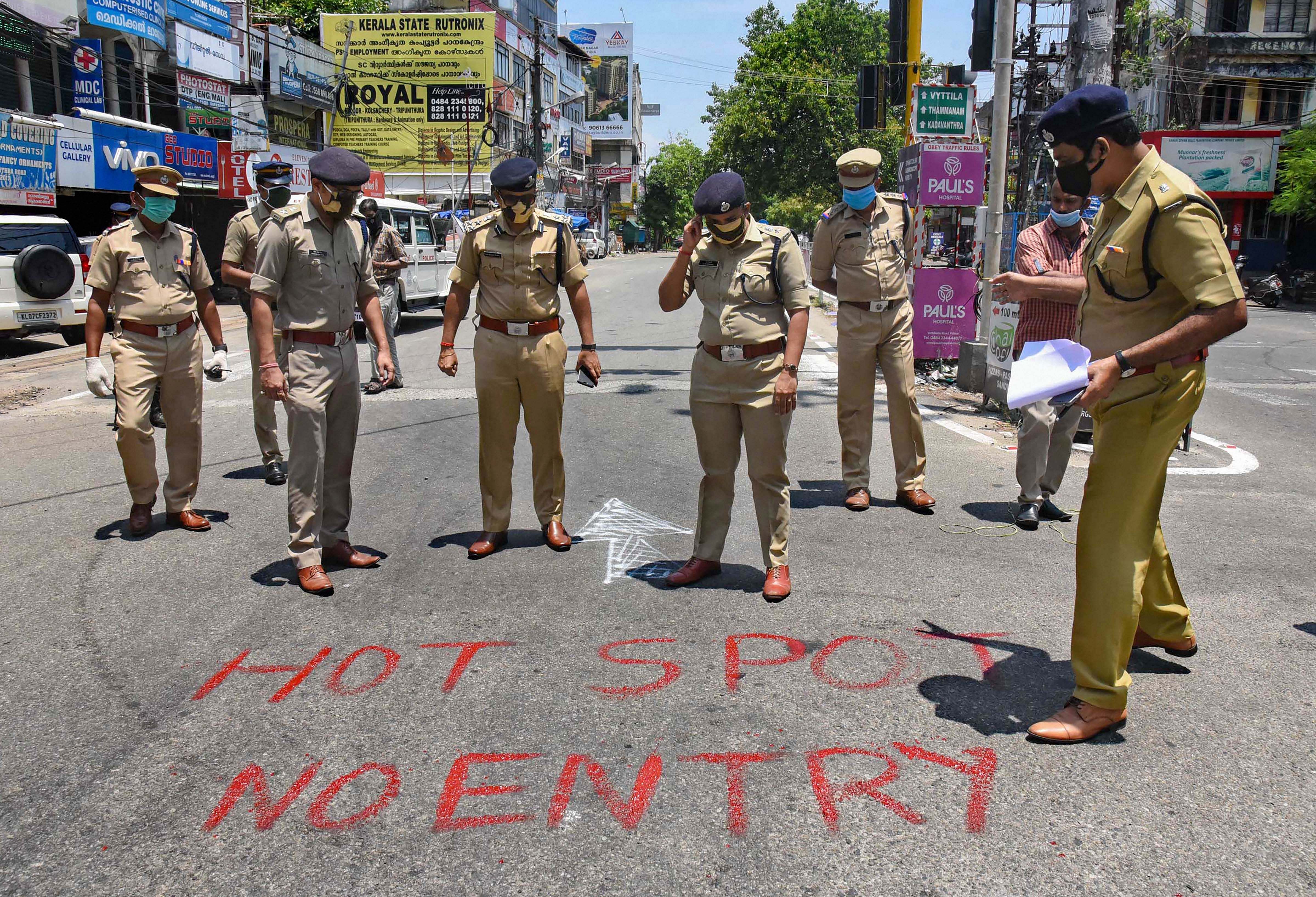 Police personnel mark a locality of Kaloor - Kathrikadavu as a COVID-19 hotspot, following emergence of positive patients, during the nationwide lockdown to curb the spread of coronavirus. (PTI Photo)