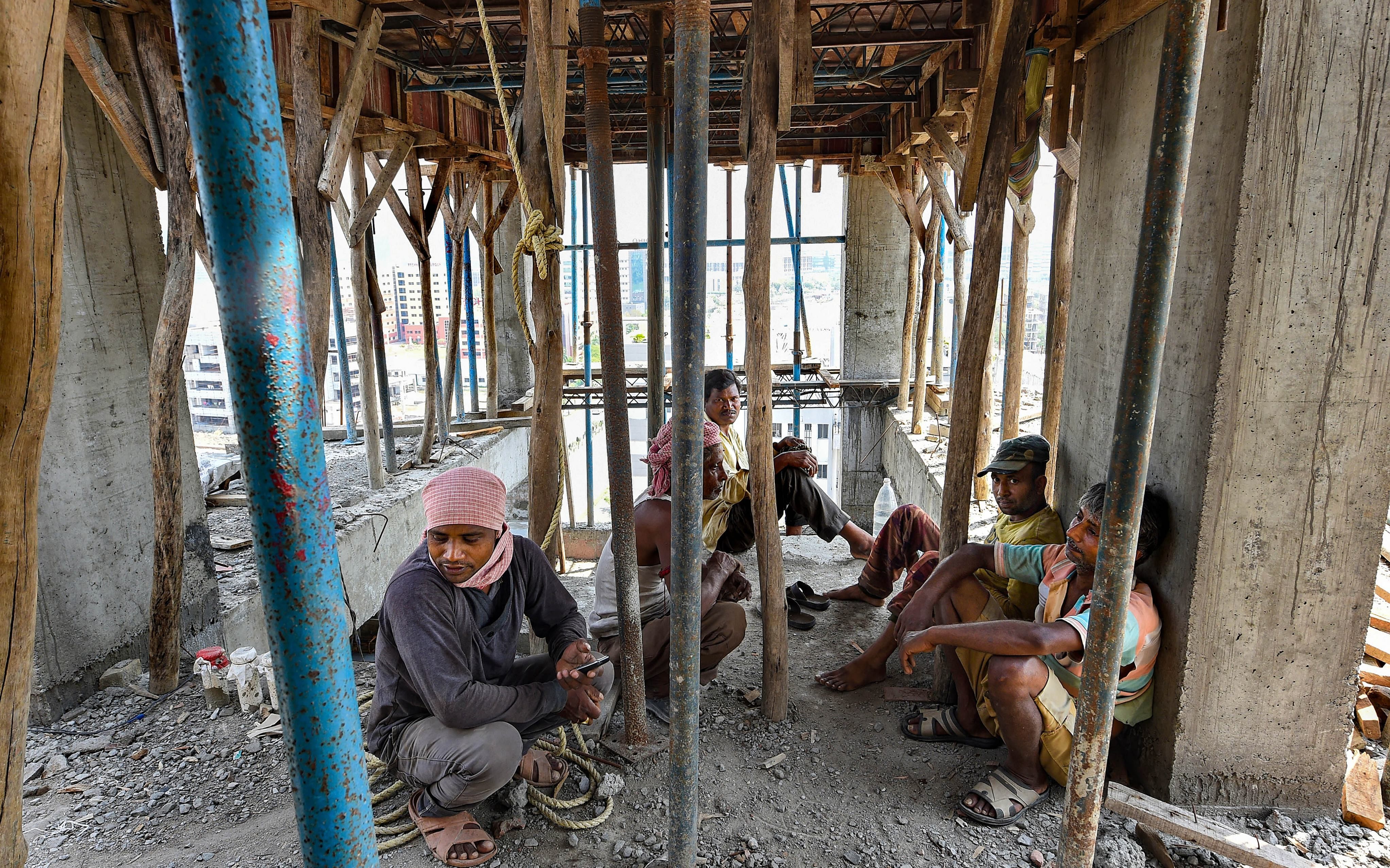 Labourers sit at an under construction building during nationwide lockdown in Kolkata, (Credit: PTI)