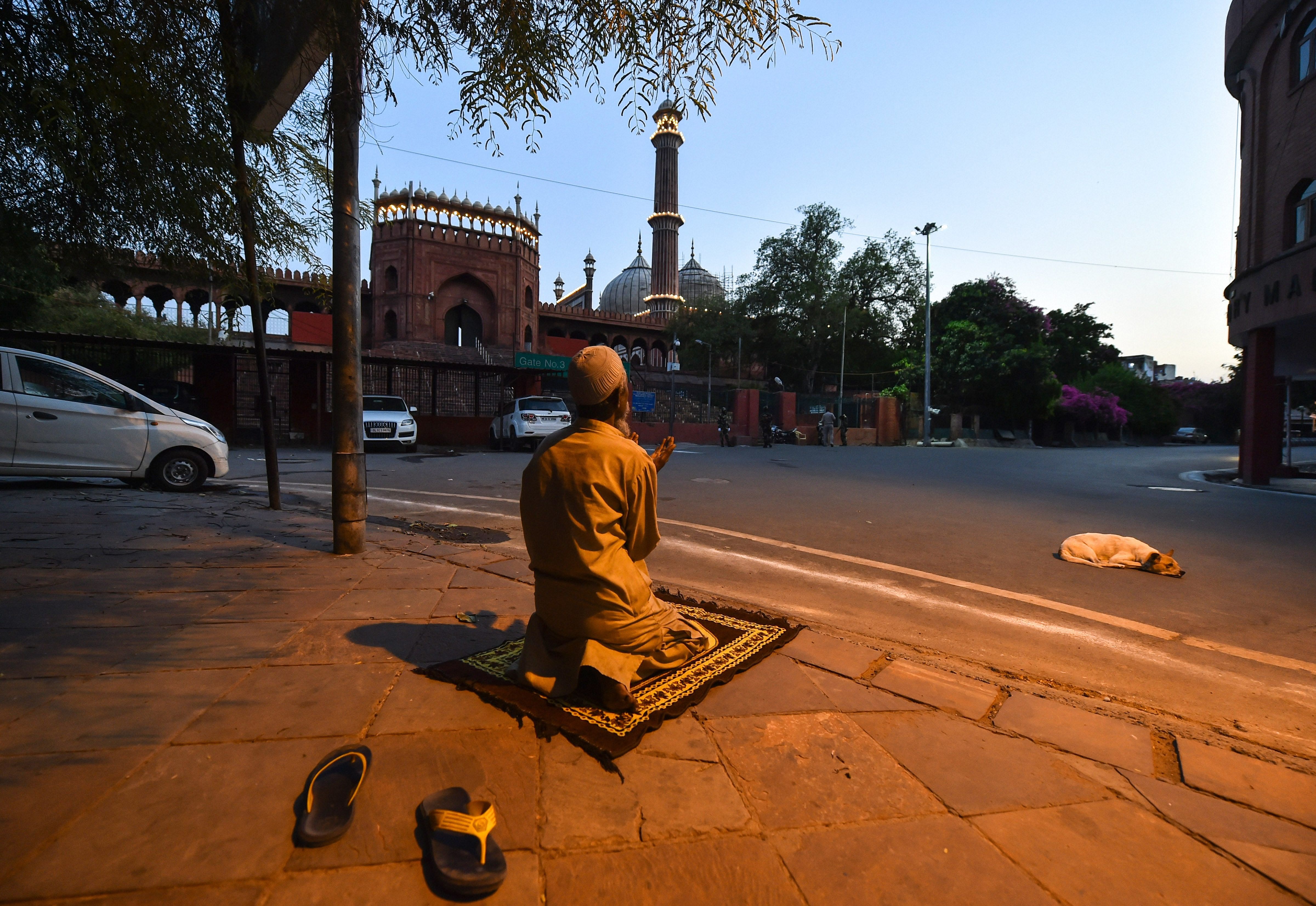 A man offers Namaz near Jama Masjid on the second day of holy month of Ramzan, during a nationwide lockdown in the wake of coronavirus pandemic, in New Delhi. (PTI Photo)