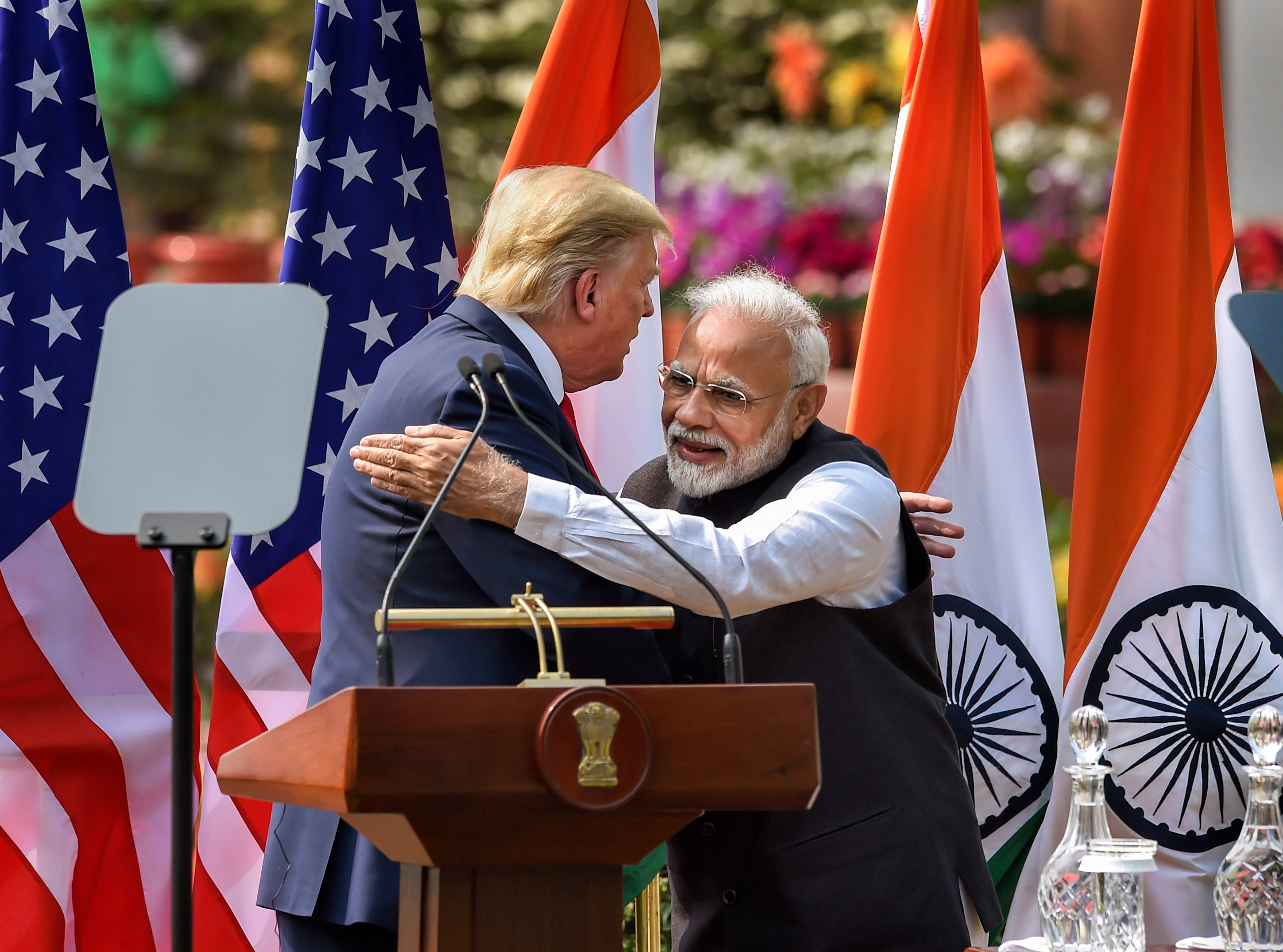 Prime Minister Narendra Modi (R) and US President Donald Trump exchange greetings after their joint press statement, at the Hyderabad House in New Delhi. (PTI Photo)