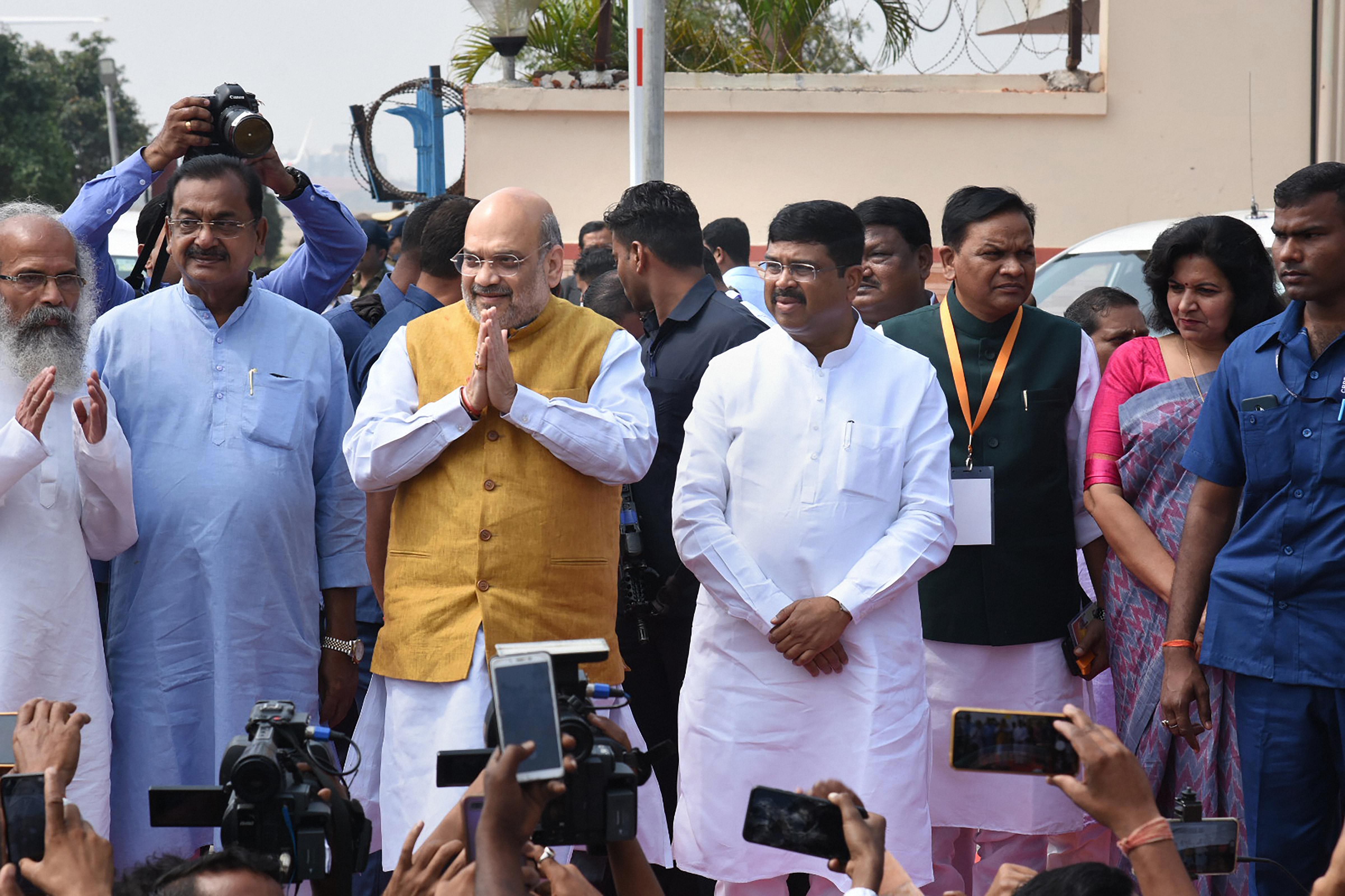 Home Minister Amit Shah is greeted by party workers at airport ahead of his of meeting of the Eastern Zonal Council (EZC) followed by a rally in support of the amended citizenship law, in Bhubaneswar. (PTI Photo)