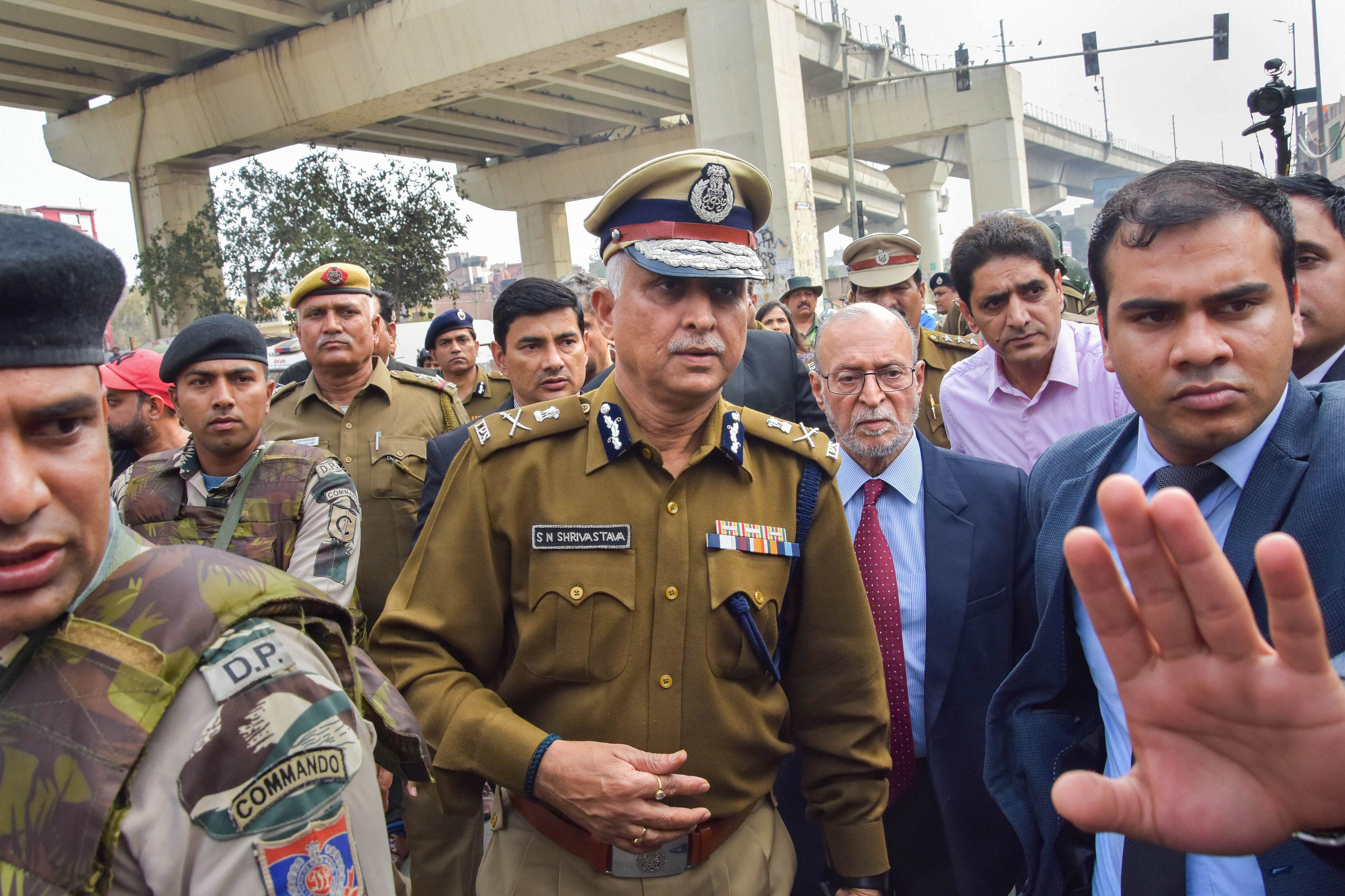 Delhi Police Commissioner S N Shrivastava (C) along with Lt Governor Anil Baijal (C on R) inspects Maujpur Chowk area of the riot-affected northeast Delhi. (PTI Photo)