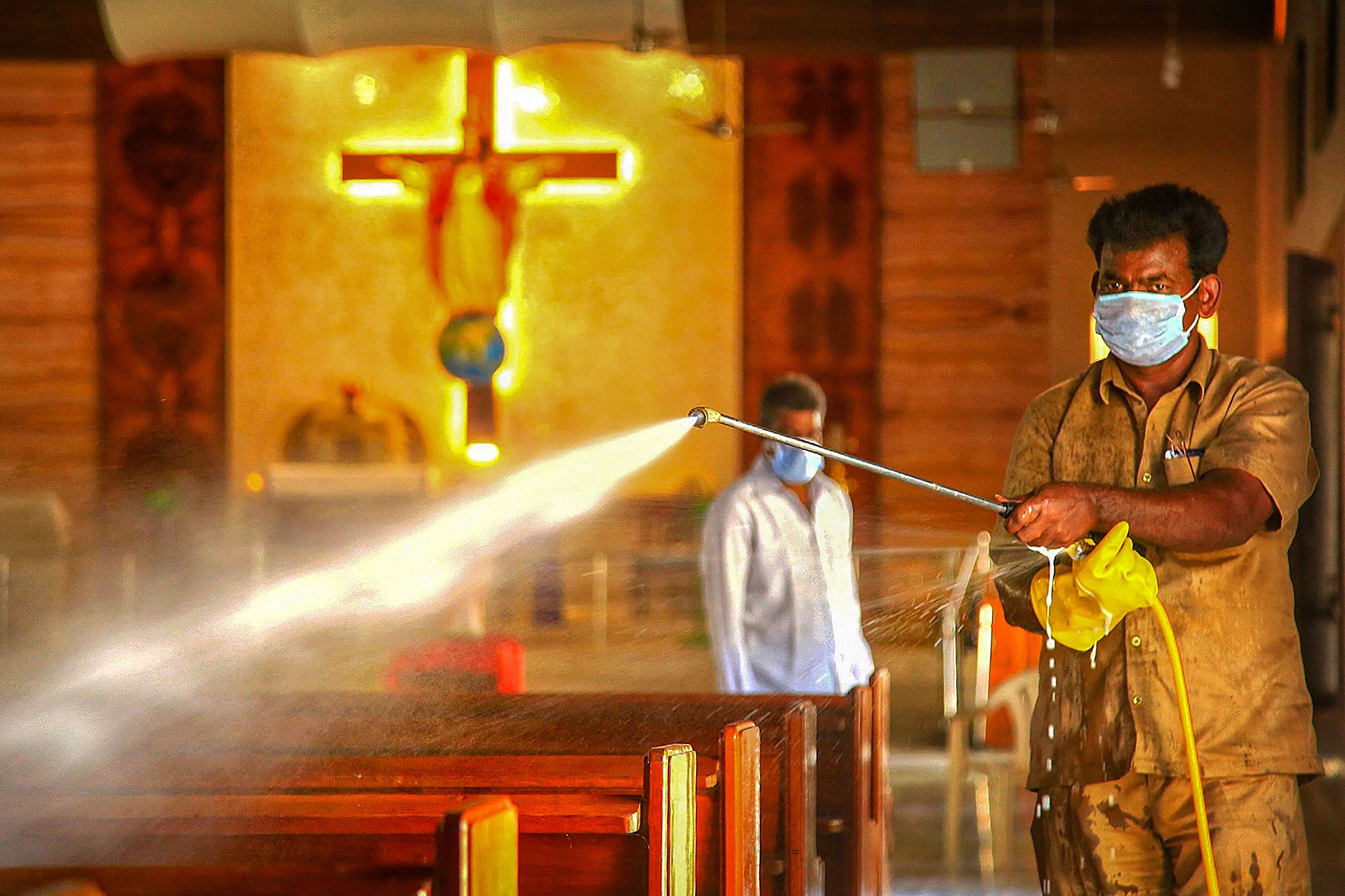 A worker sprays disinfectant inside a church during the nationwide lockdown. Credit: PTI File Photo