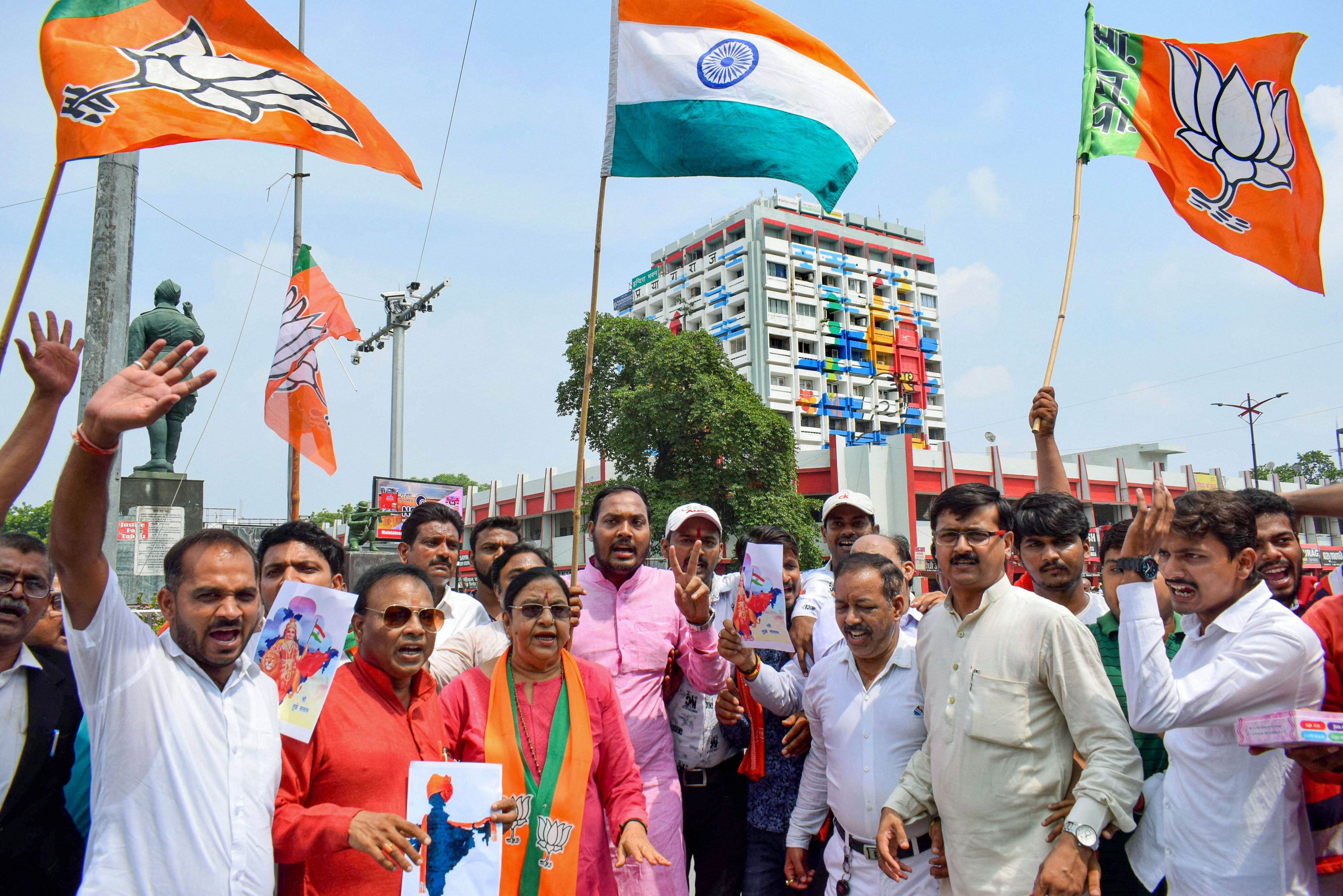 Bharatiya Janata Party workers celebrate government's decision to abolish Article 370 that gave special status to Jammu and Kashmir and moved a separate bill to bifurcate the state into two separate union territories of Jammu and Kashmir, and Ladakh. (PTI Photo)