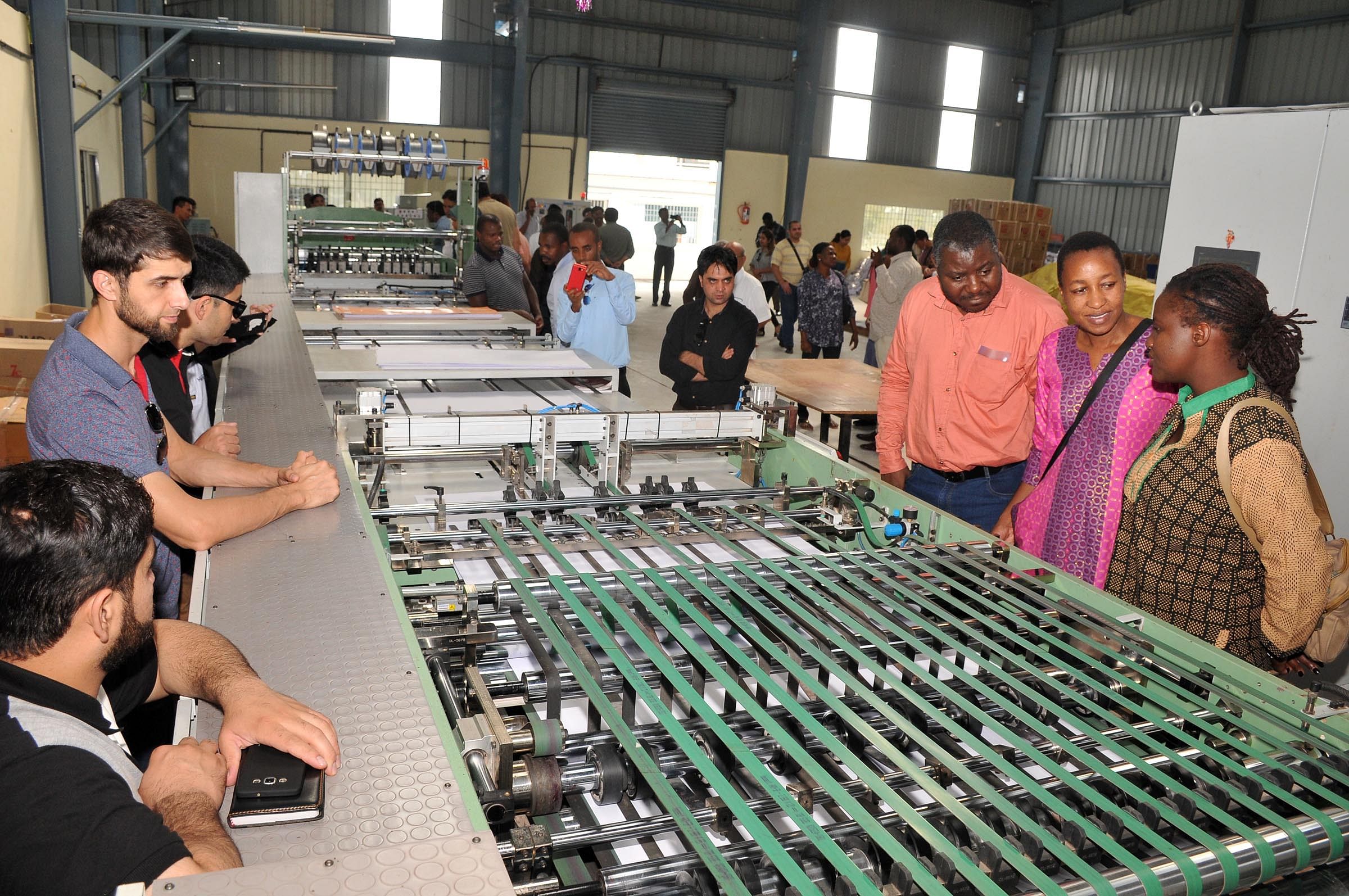 Foreign delegates take look on machinery at N J Stationary, in Mysuru