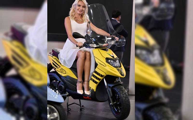 A model showcases Piaggio Aprilia SR125 motorcycle, at the Auto Expo 2018 in Greater Noida. (PTI File Photo)