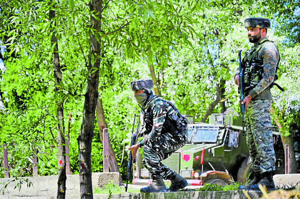 Security forces stand guard during an encounter with militants, at Beighpora area in Pulwama district of South Kashmir, Wednesday, May 6, 2020. Commander-in-Chief of Hizbul Mujahideen Riyaz Naikoo and three other militants were killed in two different operations by security forces. (PTI Photo/S. Irfan)