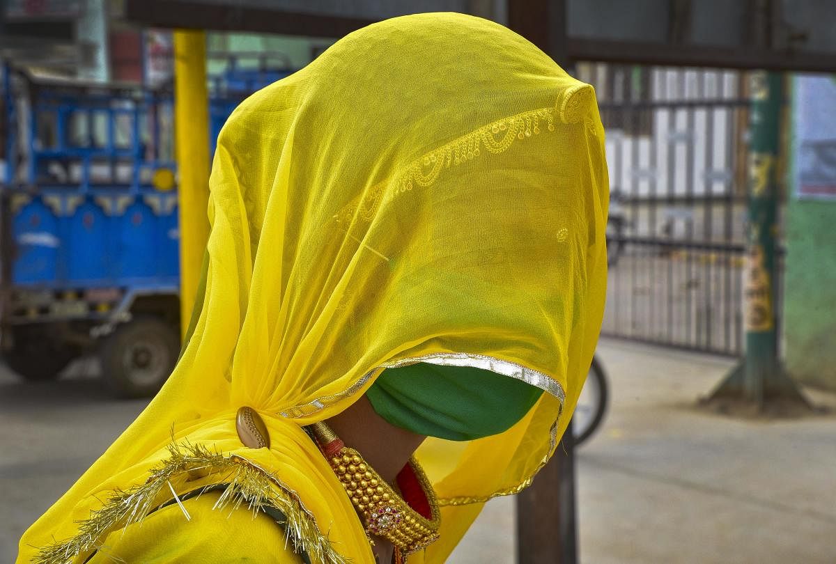 A woman wears a mask in the wake of deadly coronavirus, in Bikaner, Monday, March 23, 2020. Credit: PTI Photo