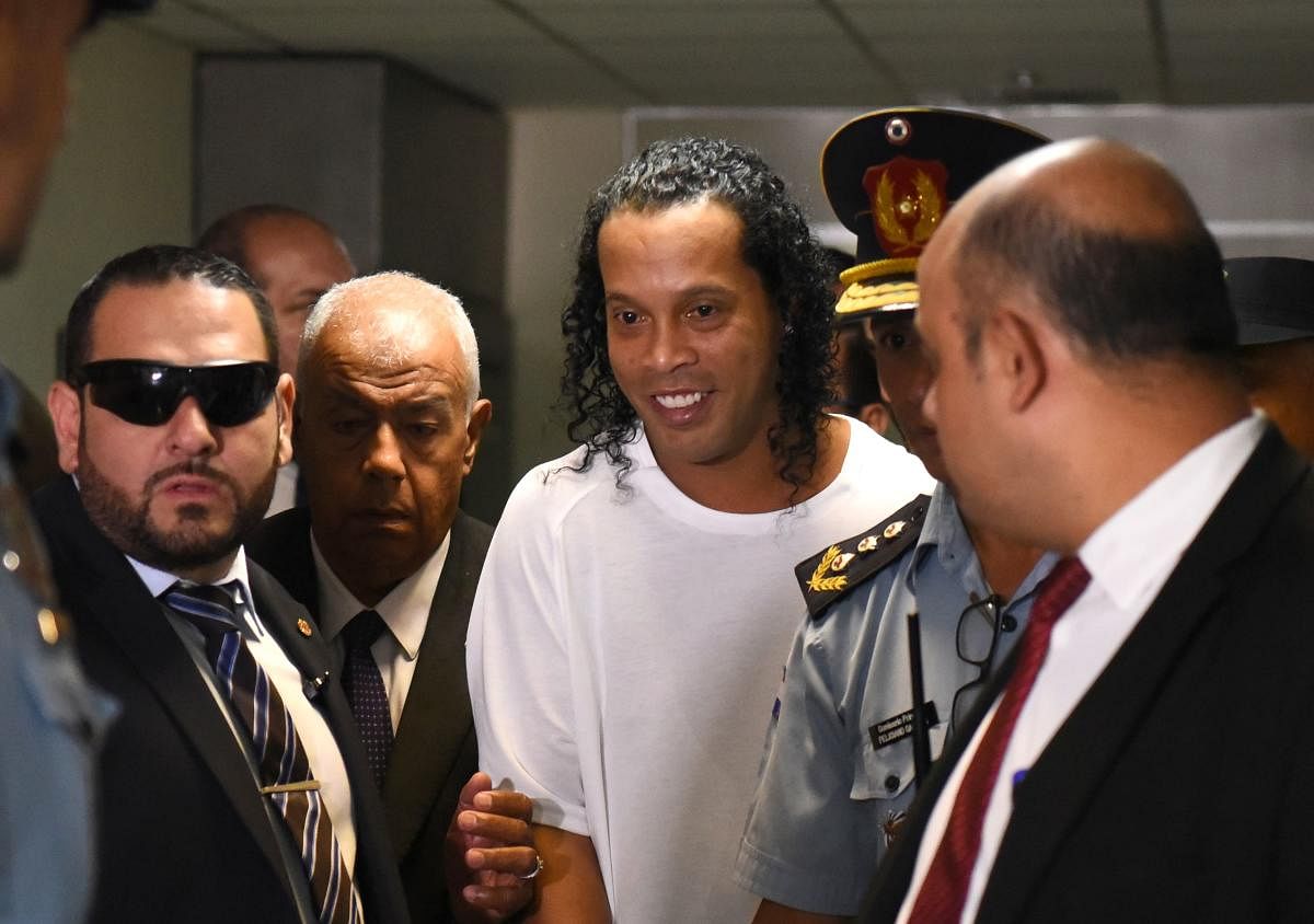 Brazilian retired football player Ronaldinho (C) arrives at Asuncion's Justice Palace to testify about his irregular entry to the country, in Asuncion. (AFP Photo)