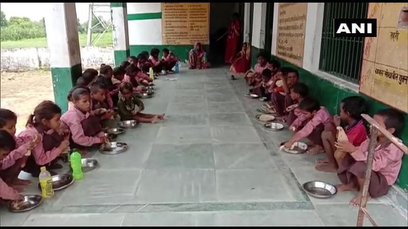 Students being served salt and roti in the Siyur Primary School. (Photo credit: ANI/twitter)