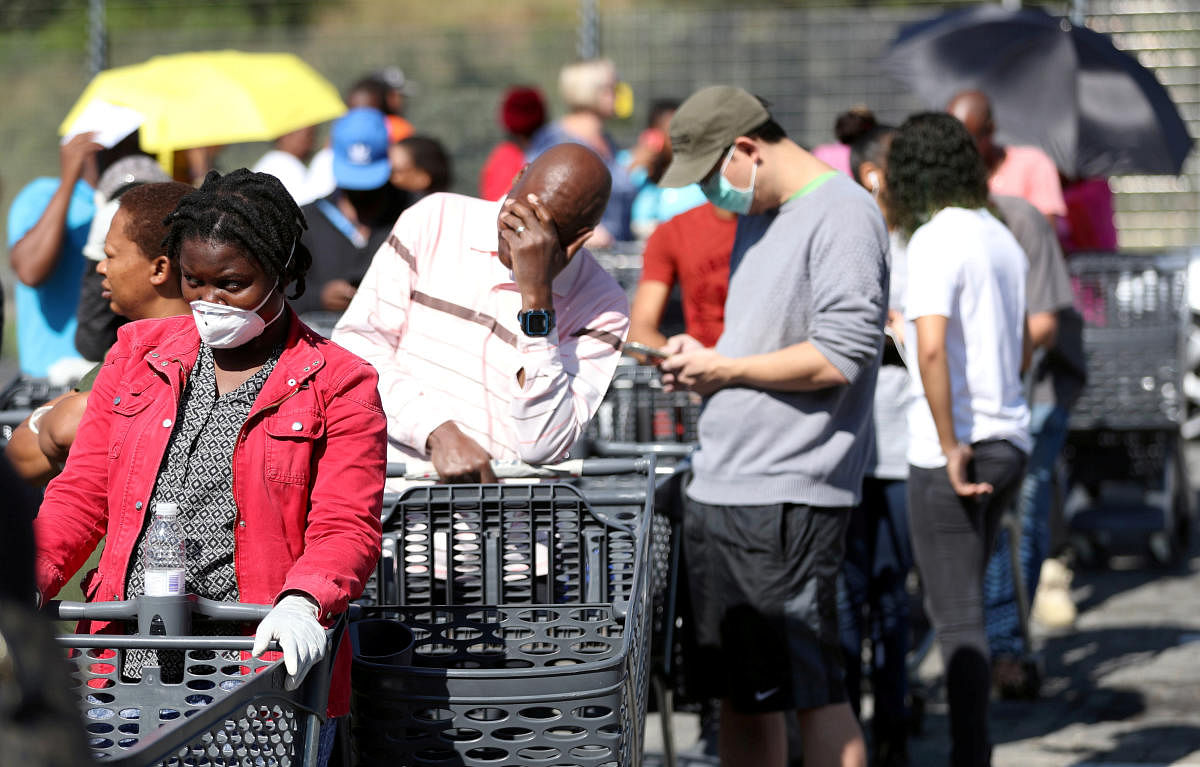 Shoppers queue to stock up on groceries at a Pick n Pay store during a nationwide lockdown of 21 days to try to contain the coronavirus disease (COVID-19) outbreak, in Johannesburg, South Africa, March 24, 2020. REUTERS/Siphiwe Sibeko