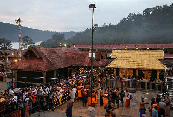 Hindu devotees wait in queues inside the premises of the Sabarimala temple in Pathanamthitta. (Reuters photo)