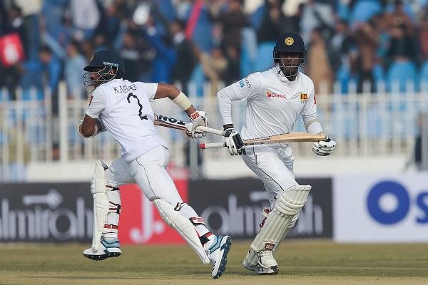 Sir Lanka's Kusal Mendis (L) and Oshada Fernando take a run during the first day of the first Test cricket match between Pakistan and Sri Lanka at the Rawalpindi Cricket Stadium in Rawalpindi on December 11, 2019. (Photo by Aamir QURESHI / AFP)