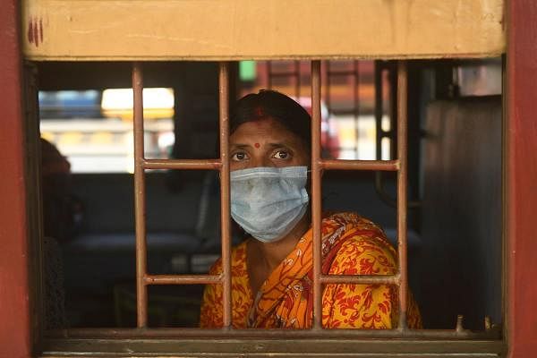 A patient sits on a train as she arrives from the Southern Indian city of Vellore after receiving treatment as the government eased a nationwide lockdown imposed as a preventive measure against the COVID-19 coronavirus, at the Howrah Railway station in Kolkata on May 12, 2020. (Credit: AFP Photo)