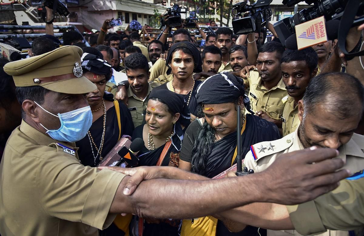 Four transgenders draped in sarees, who were earlier denied permission to visit the Sabarimala temple, arrive to have their darshan of the Lord Ayyappa shrine in Sabarimala, Tuesday morning, Dec 18, 2018. The temple town has witnessed several protests by various groups since the September 28 Supreme Court verdict which allowed women of all ages to enter the temple. (PTI Photo)