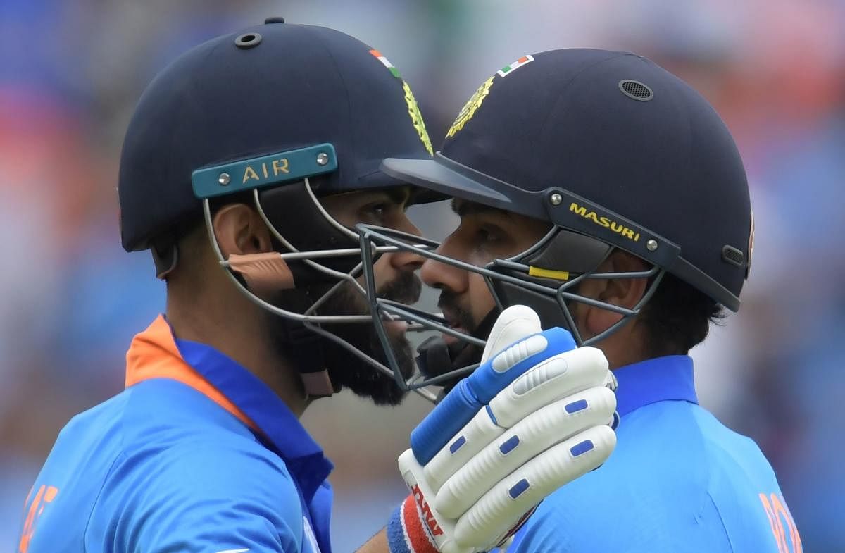 India's captain Virat Kohli (L) embraces Rohit Sharma during the 2019 Cricket World Cup group stage match between Bangladesh and India at Edgbaston in Birmingham, central England, on July 2, 2019. (Photo by AFP)