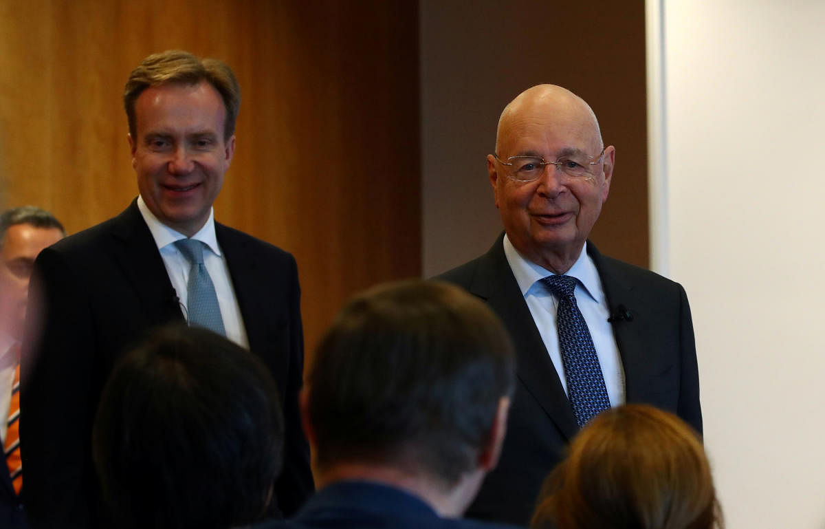 Klaus Schwab, founder and Executive Chairman of the World Economic Forum (WEF), and WEF President Borge Brende arrive for a news conference ahead of the Davos annual meeting in Cologny near Geneva. (Reuters Photo)