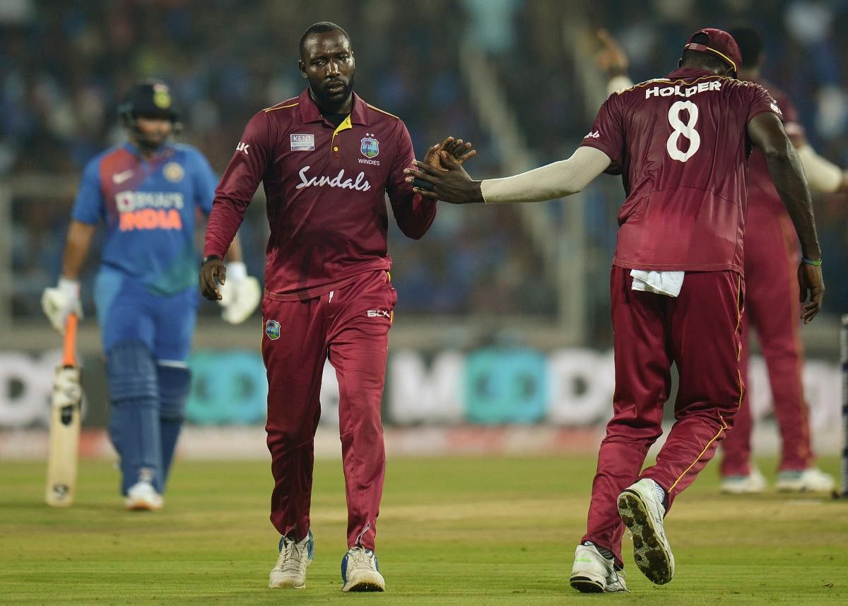 West Indies' Kesrick Williams (L) celebrates the wicket of India's Ravindra Jadeja during the second T20 international cricket match. (AFP Photo)