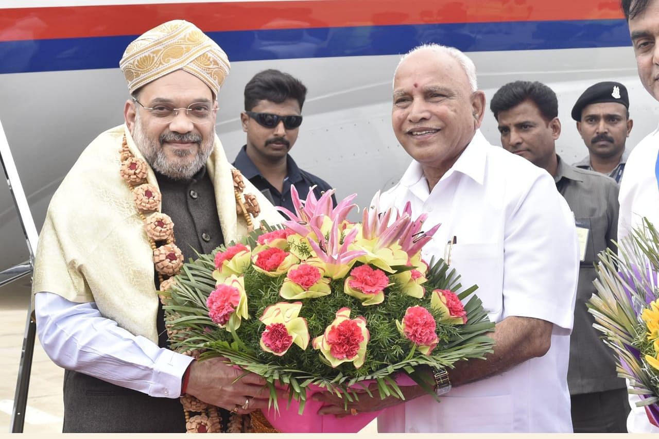 CM BS Yediyurappa receives Union Home Minister Amit Shah at the HAL Airport. (DH Photo)
