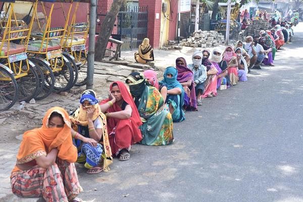Women wait for their turn outside a bank to withdraw cash from their accounts during a nationwide lockdown in the wake of coronavirus pandemic, in Mathura, Tuesday, April 21, 2020. (PTI Photo)