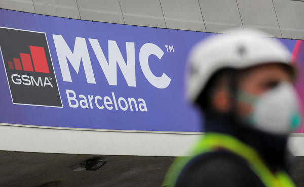 An employee is pictured next to the logo of MWC20 (Mobile World Congress) in Barcelona, Spain February 12, 2020. (Reuters Photo)
