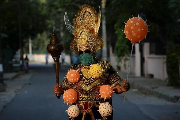 A man dressed as 'Yamraj', the Hindu mythical angel of death, campaigns to raise awareness on the importance to stay home and maintain social distancing during an event organised by Delhi police as India continues to remain under a nationwide lockdown as a preventive measure against the spread of the COVID-19 coronavirus, in New Delhi on April 28, 2020. (AFP Photo by Sajjad Hussain)