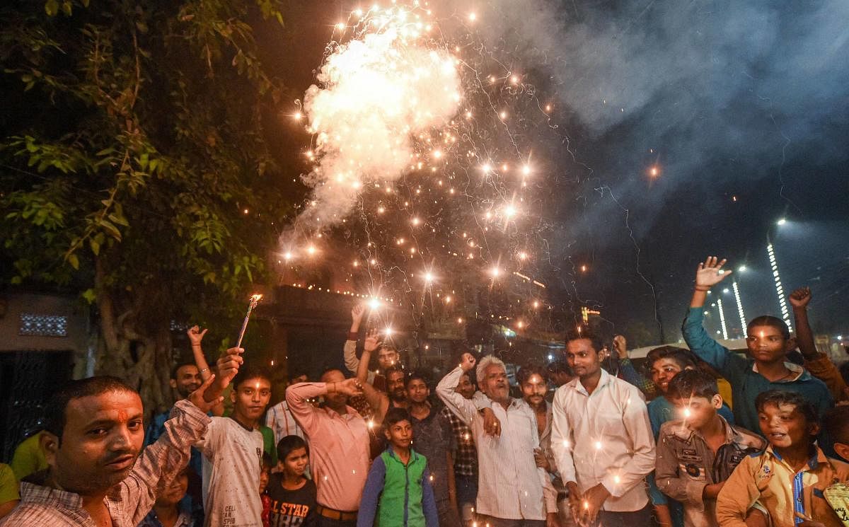 Residents of Sadatganj area burst fire crackers outside their houses to celebrate SCs judgement in Ram Janmabhoomi case, in Ayodhya. PTI