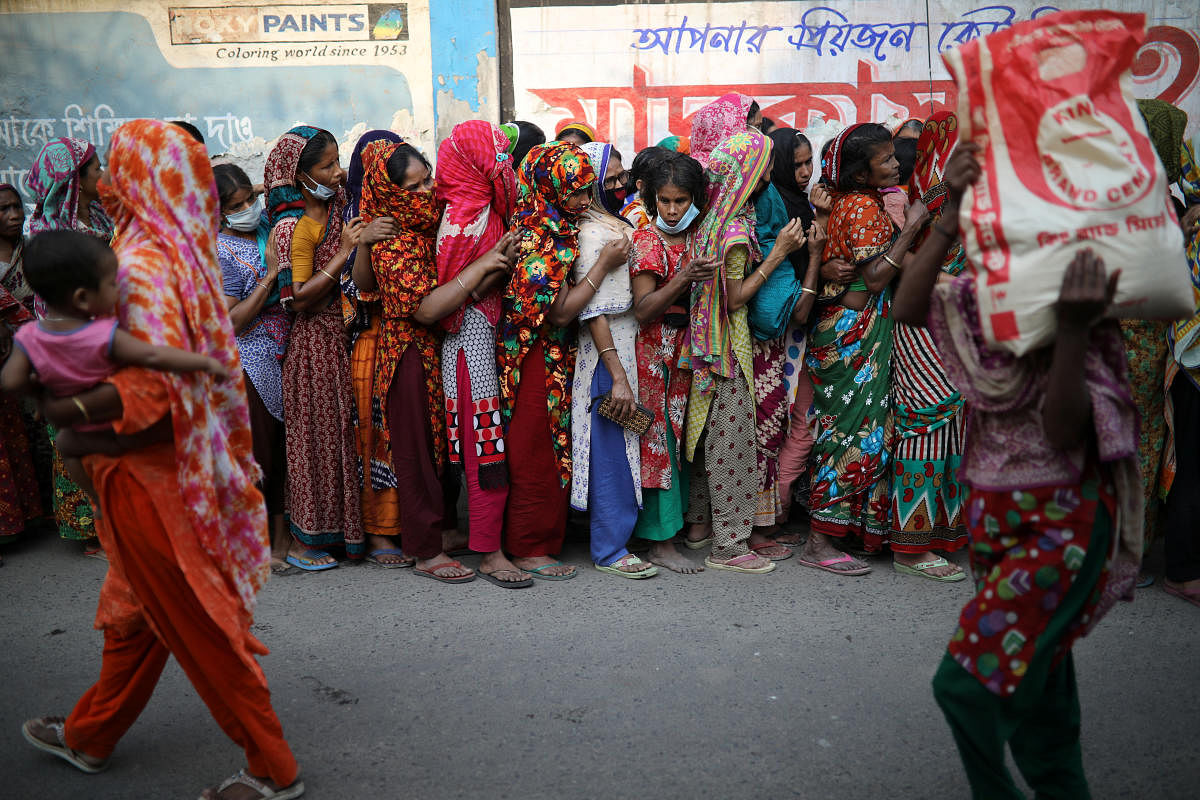 Women stand in a queue to receive relief supplies provided by local community amid the coronavirus disease (COVID-19) outbreak in Dhaka, Bangladesh, April 1, 2020. Credit: Reuters Photo