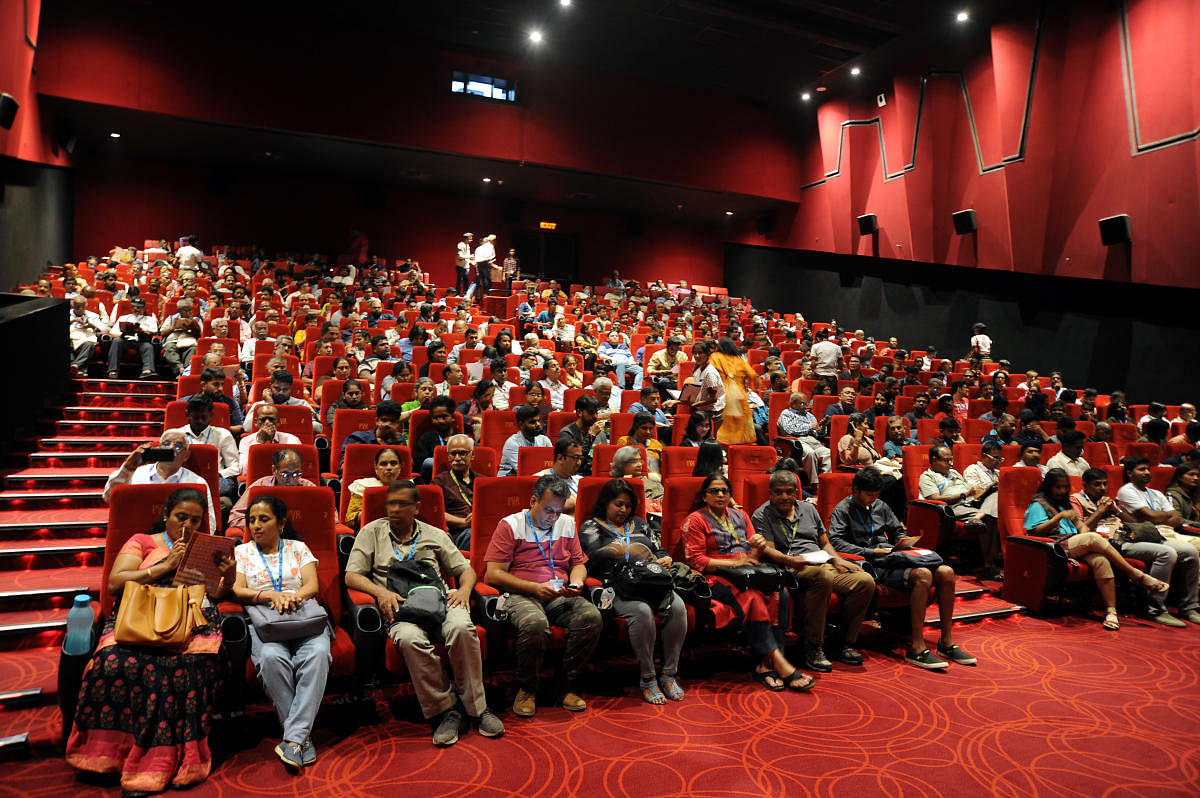 Film buffs watch their favorite film during the BIFFES at Orion Mall in Bengaluru on Saturday. | DH Photo: Pushkar V