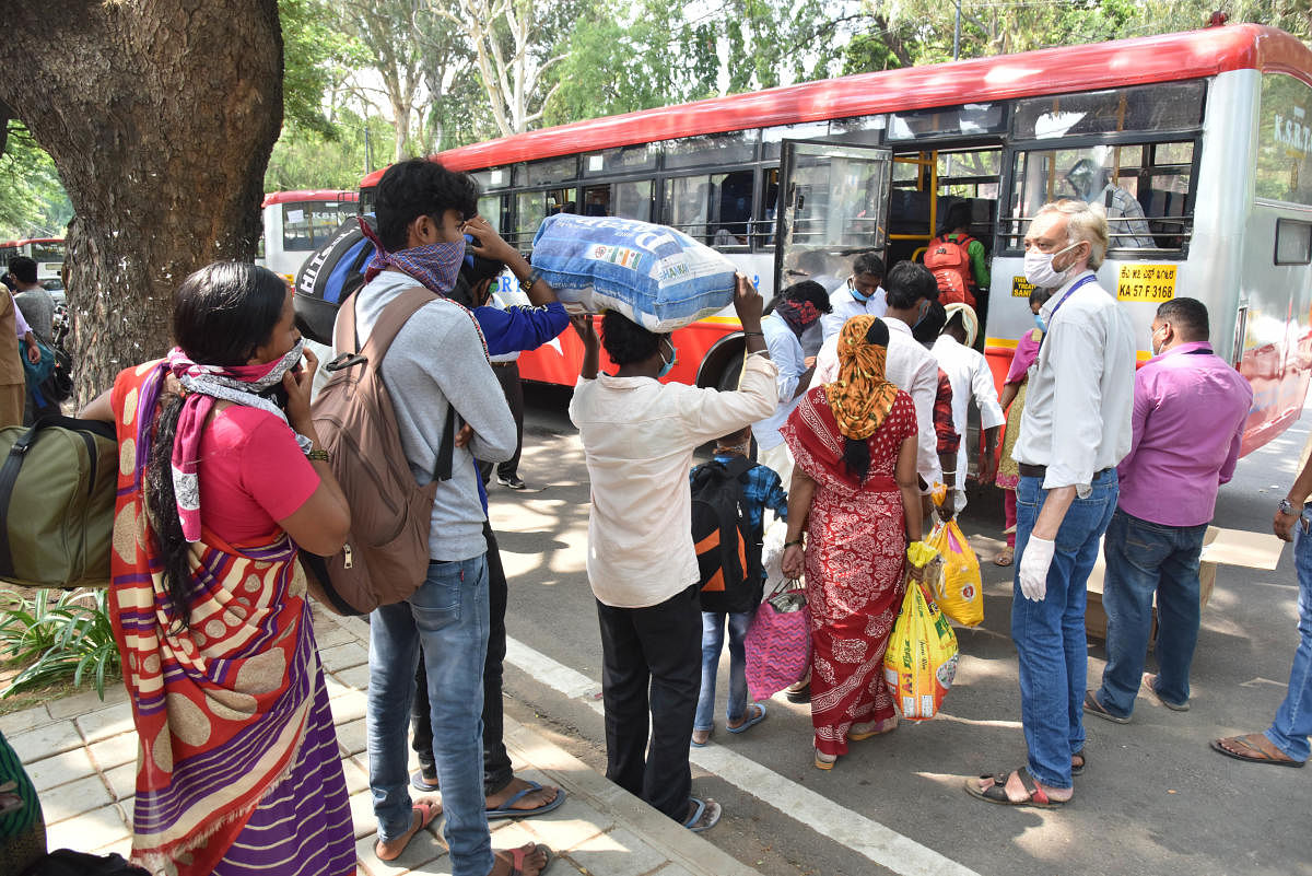 Migrants workers and their family leave Bengaluru and going to home town by KSRTC bus after don sanitization, on KG Road in Bengaluru on Friday, May 01, 2020. Photo by Janardhan B K (DH Photo)