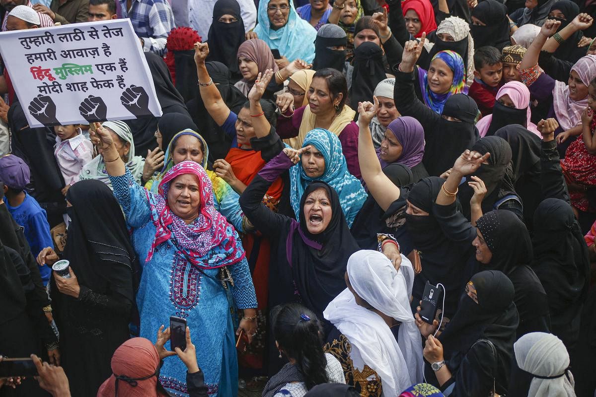 Women raise slogans during a protest against the Citizenship Amendment Act (CAA). (PTI Photo)