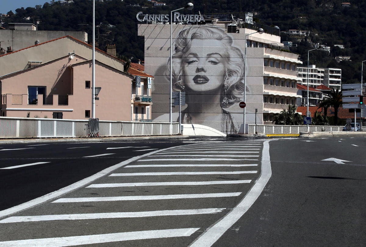 A mural showing a portrait of actress Marilyn Monroe by A. Fresco is seen in a deserted street of Cannes as a lockdown is imposed to slow the rate of the coronavirus disease. Reuters