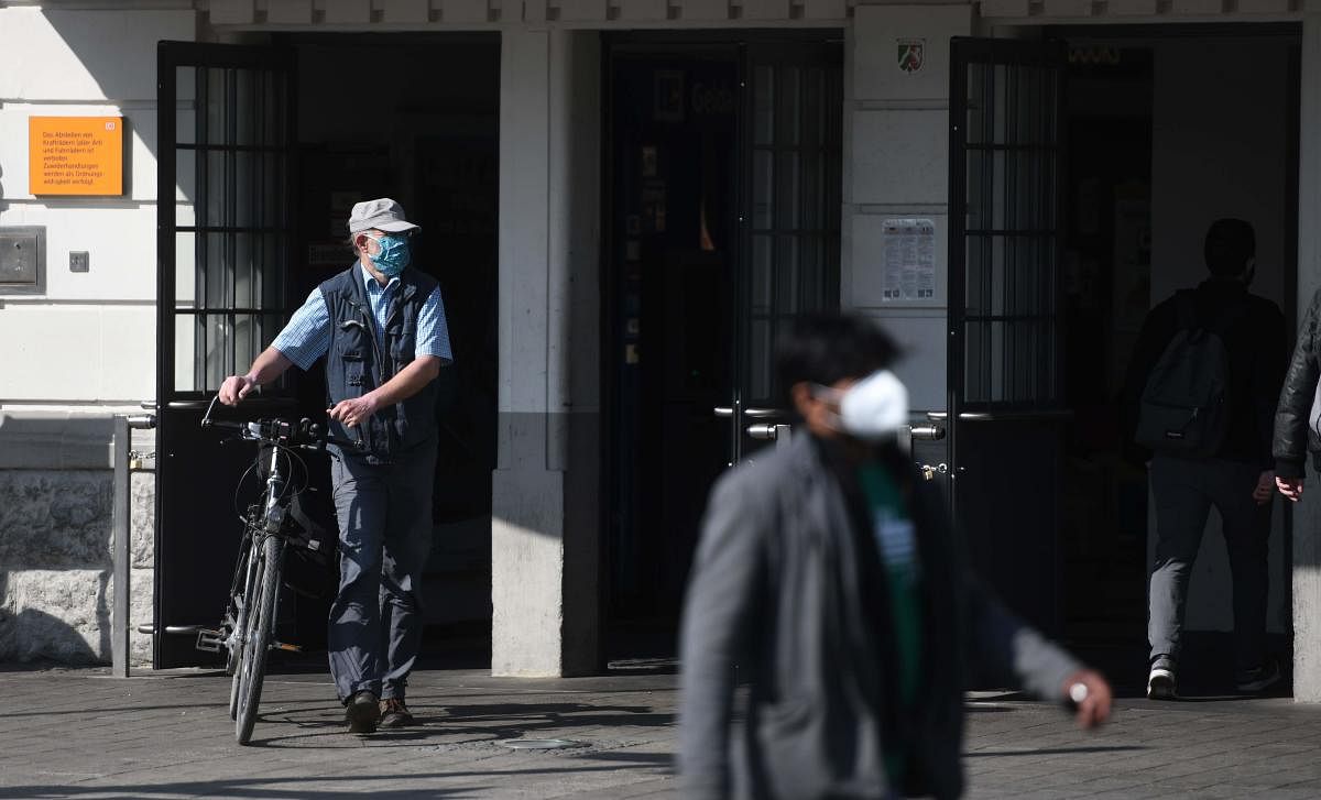 People wear protective face masks at the main railway station in Hamm on April 27, 2020, amid the new coronavirus COVID-19 pandemic. Credit: AFP Photo