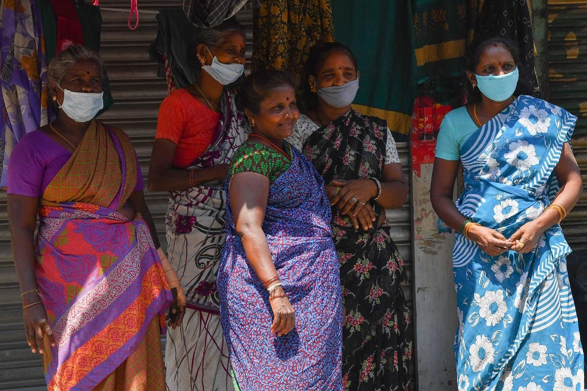 Homeless people wearing facemasks wait to collect food being distributed by a local Non-Governmental Organisation during a government-imposed nationwide lockdown as a preventive measure against the COVID-19 coronavirus in Mumbai on March 29, 2020. Credit: AFP Photo