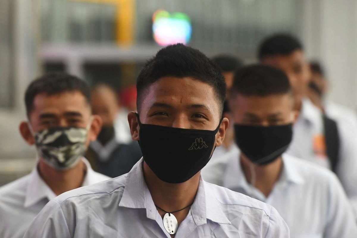 Indian security personnel wearing facemasks as a preventive measure against the spread of the COVID-19 coronavirus outbreak, enter the Netaji Subhas Chandra Bose International Airport in Kolkata on March 7, 2020. Credit: AFP Photo