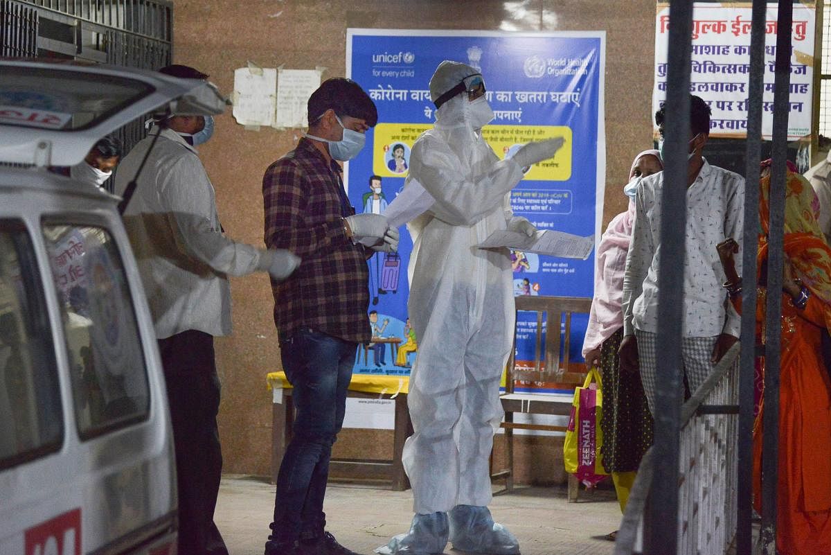  medic checks the temperature of a suspected COVID-19 patient during a nationwide lockdown in the wake of coronavirus outbreak (PTI Photo)