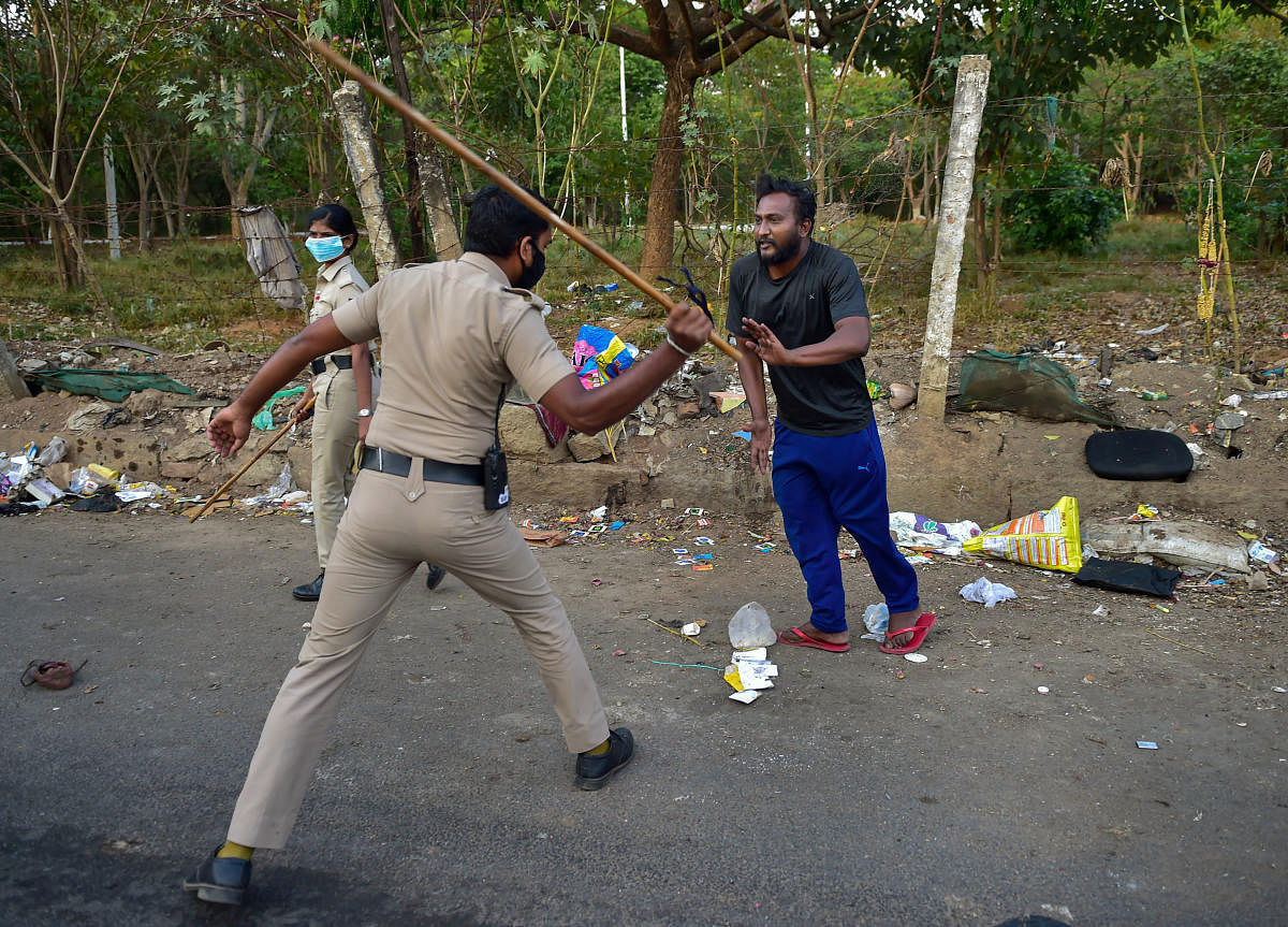 Police personnel cane charge a commuter for coming out during restrictions on the second day of the lockdown in the wake of novel coronavirus(COVID-19) (PTI Photo)