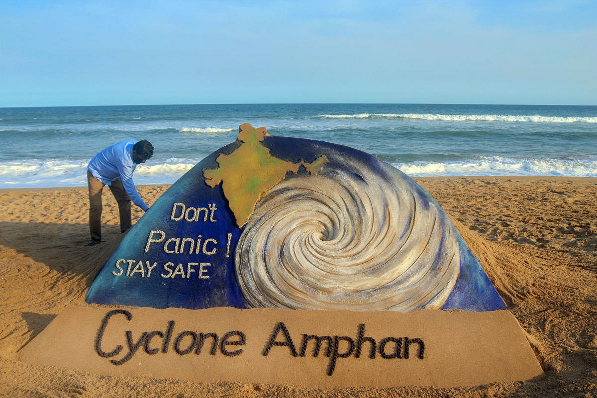 Sand artist Sudarsan Pattnaik gives final touches to his sand sculpture on cyclone Amphan at Puri beach, Monday, May 18, 2020. Credit: PTI Photo