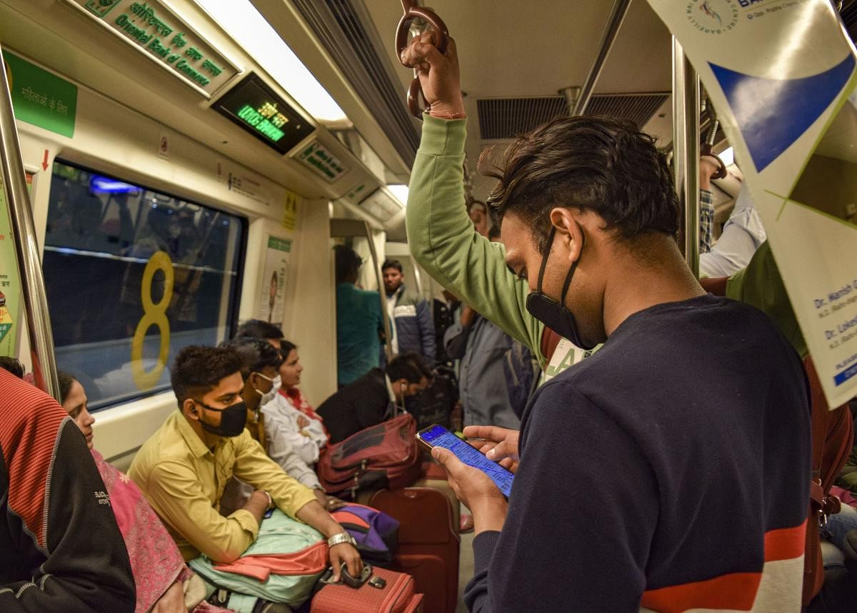 Passengers wear masks while travelling in a Metro in New Delhi, Monday, March 16, 2020. (PTI Photo)