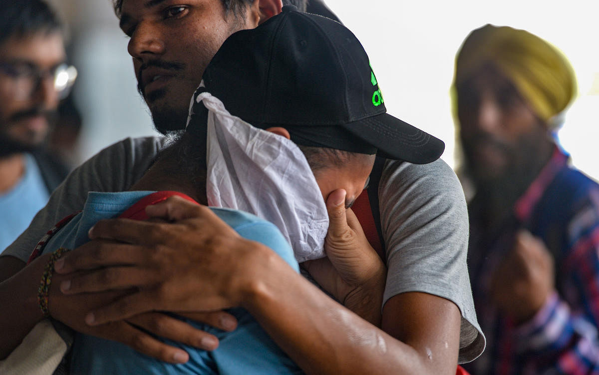 An Indian national who did not have a condition of regular stay in Mexico breaks down at Indira Gandhi International Airport after being deported, in New Delhi, Friday, Oct. 18, 2019. Mexico's migration authorities deported 311 Indians, including a woman, from various parts of the country amidst its stepped up efforts to check people illegally crossing its borders following pressure from the US. (PTI Photo/Vijay Verma)